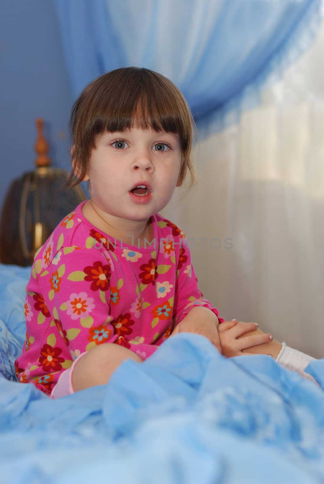 The little girl on a bed. The three-year child of the European nationality