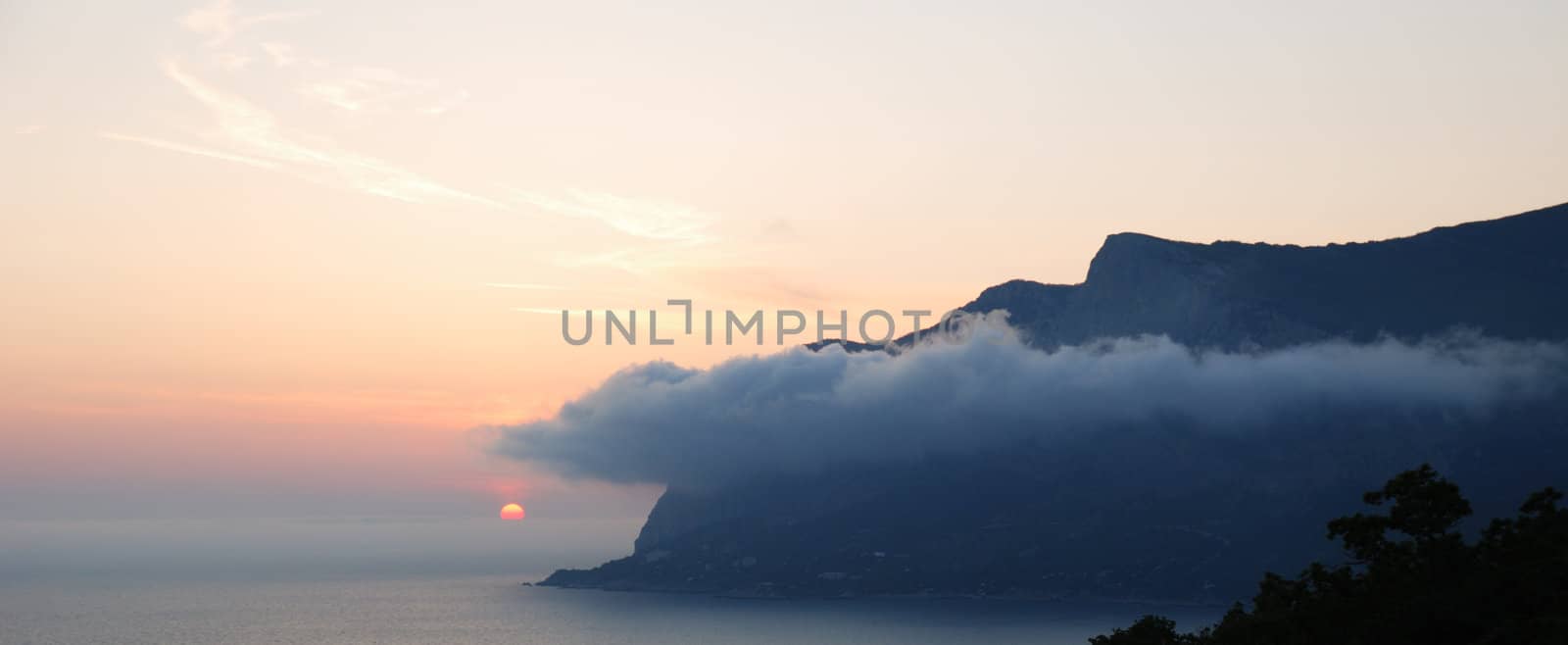 Sunset. A picturesque sunset with fantastic foggy under mountain