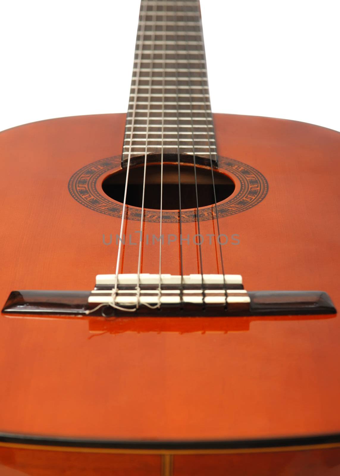 Acoustic six-string guitar. Covered by a brown varnish 