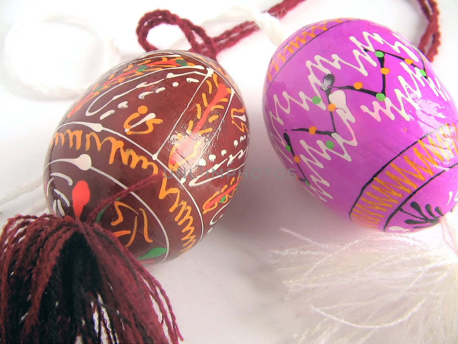 Easter eggs painted by bright paints   - with the passed cords (handmade) - isolated white background  - with the passed cords