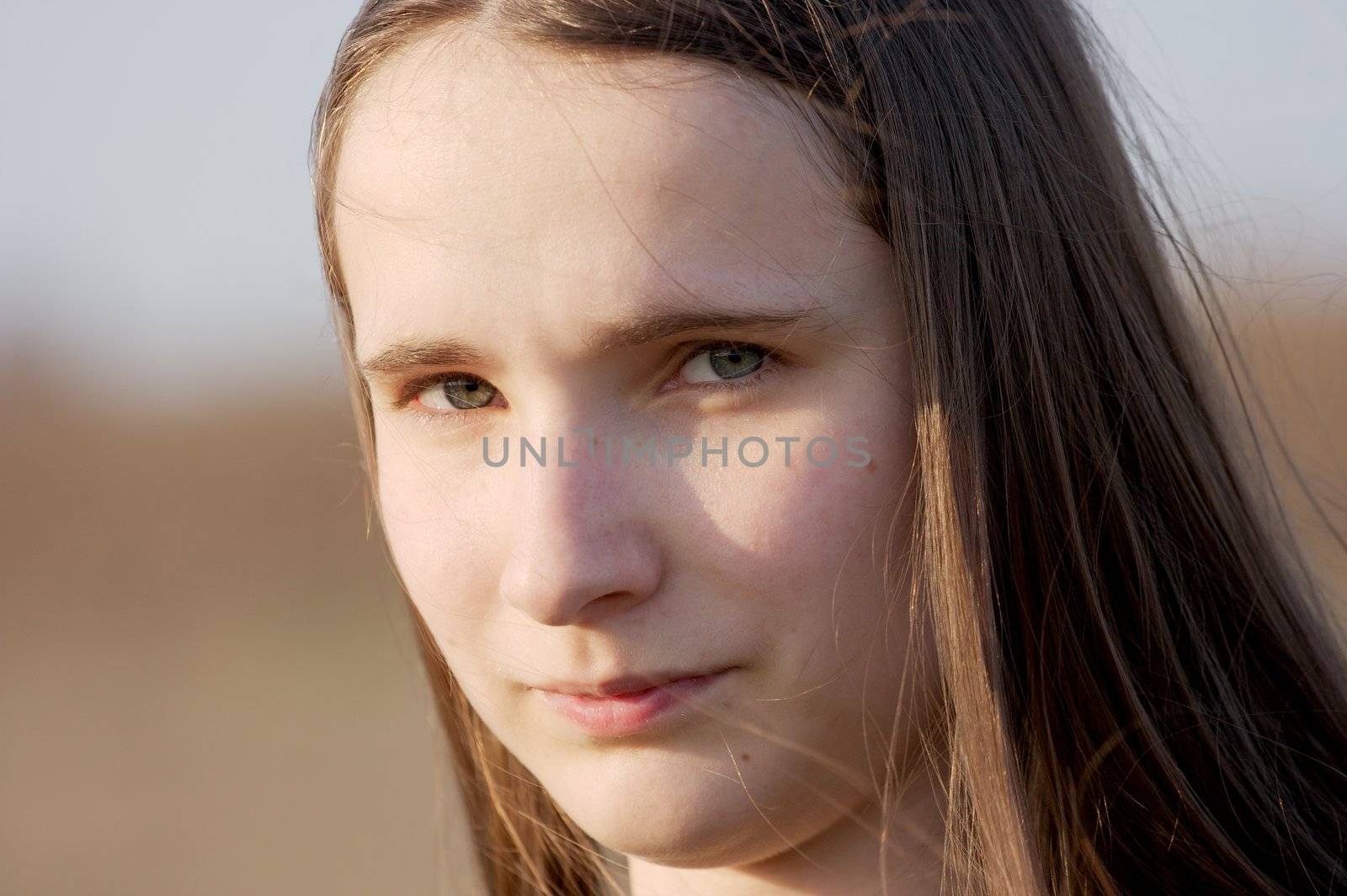 Outdoor portrait of girl with long hair in the wind