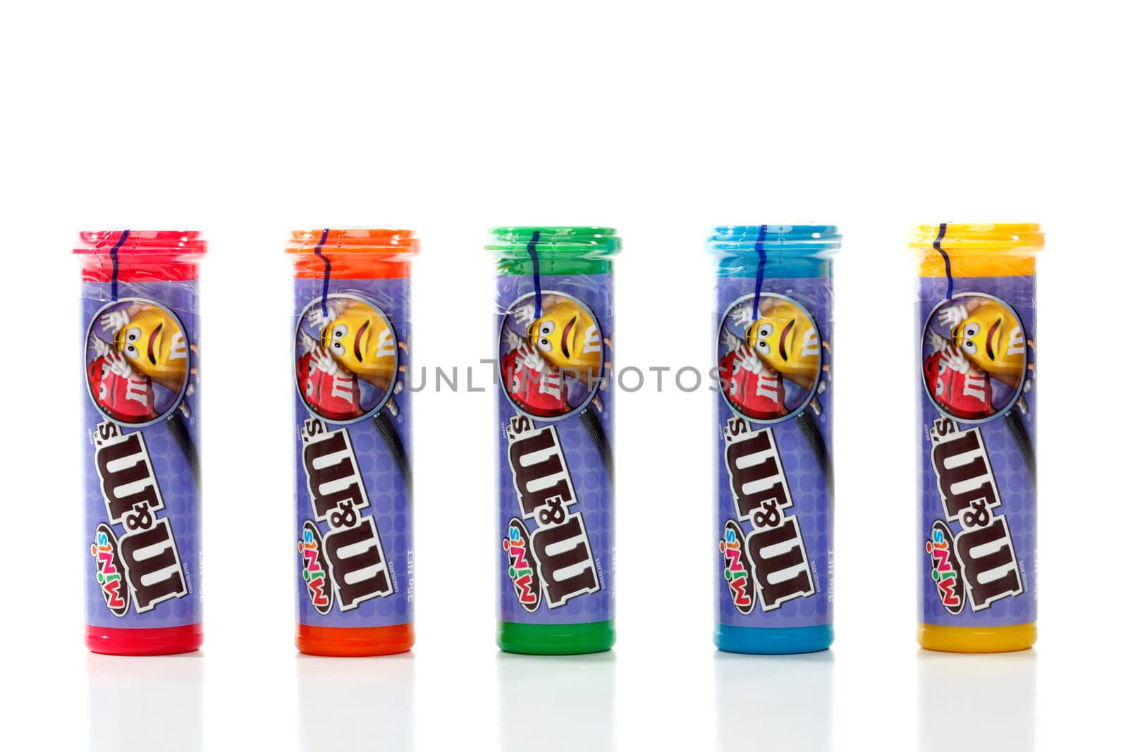 Five sealed coloured tubes containing M&M minis.  A smaller version of the traditional M&M chocolate candy.  Over 100 minis in each tube.  White background.  Editorial Use Only.