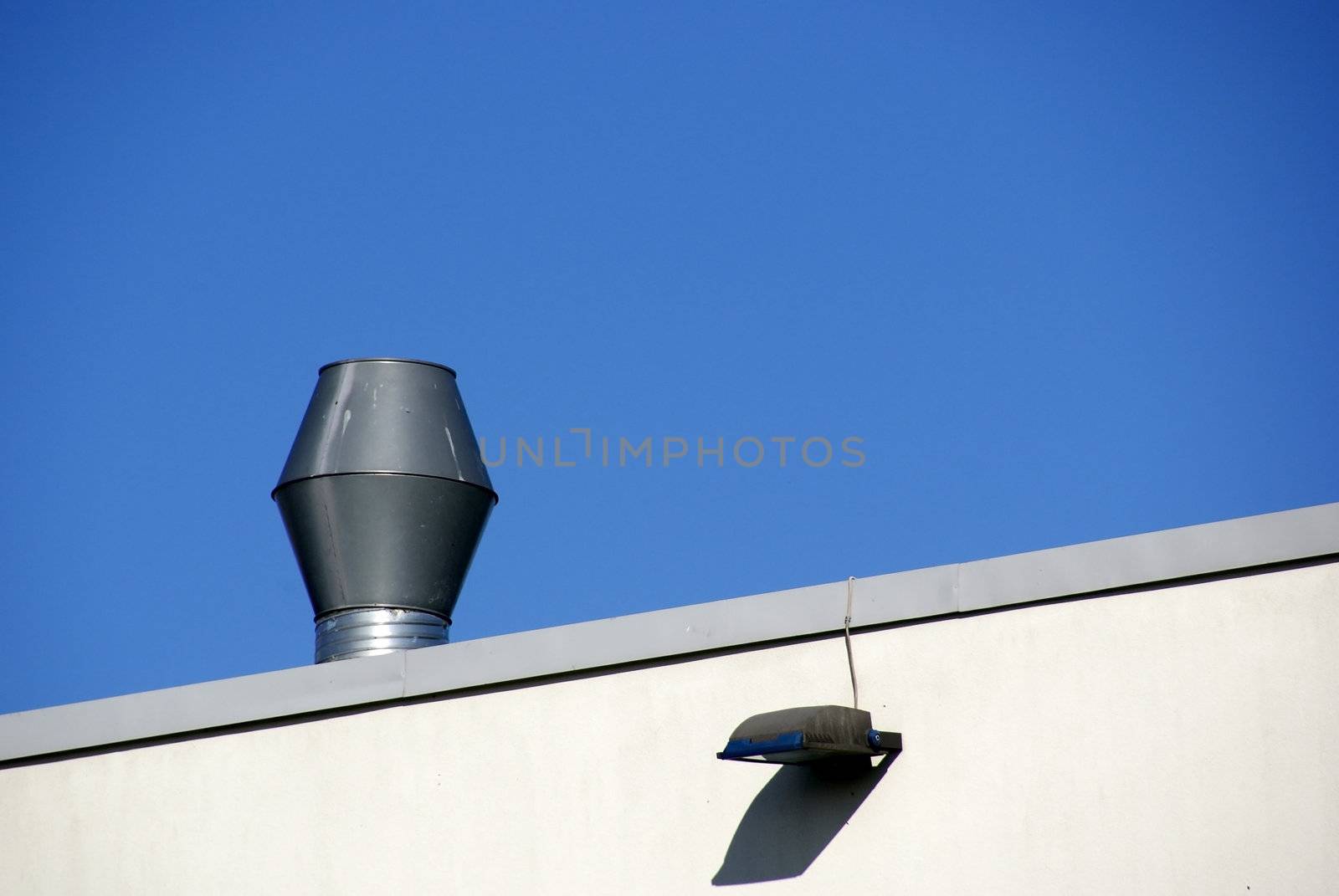 Pipe of ventilation are located on a roof of a  building