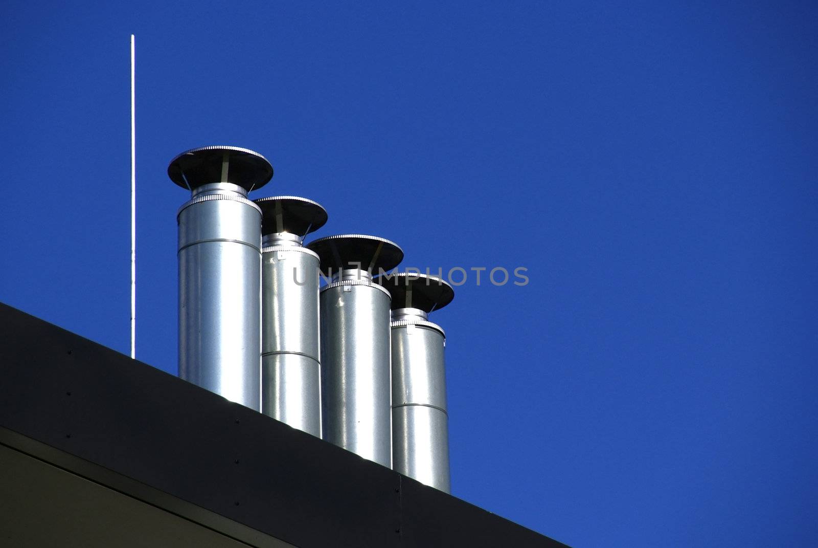 Pipes of ventilation on a background of the blue sky