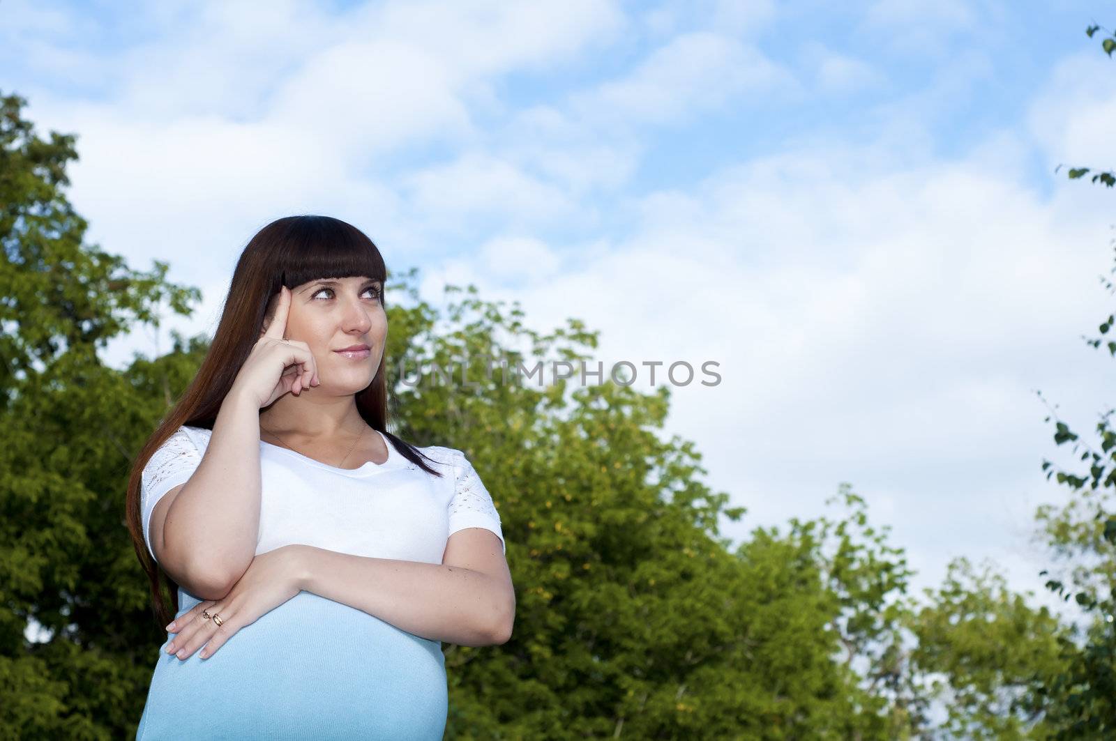 Pregnant Young Woman smile in summer park