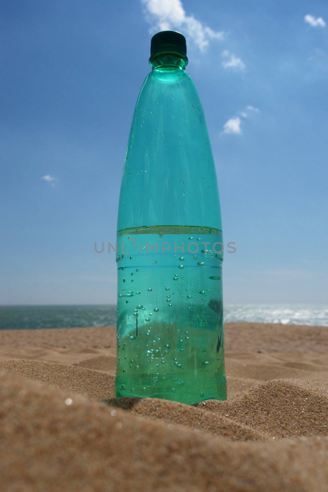 water bottle at the beach on a hot day