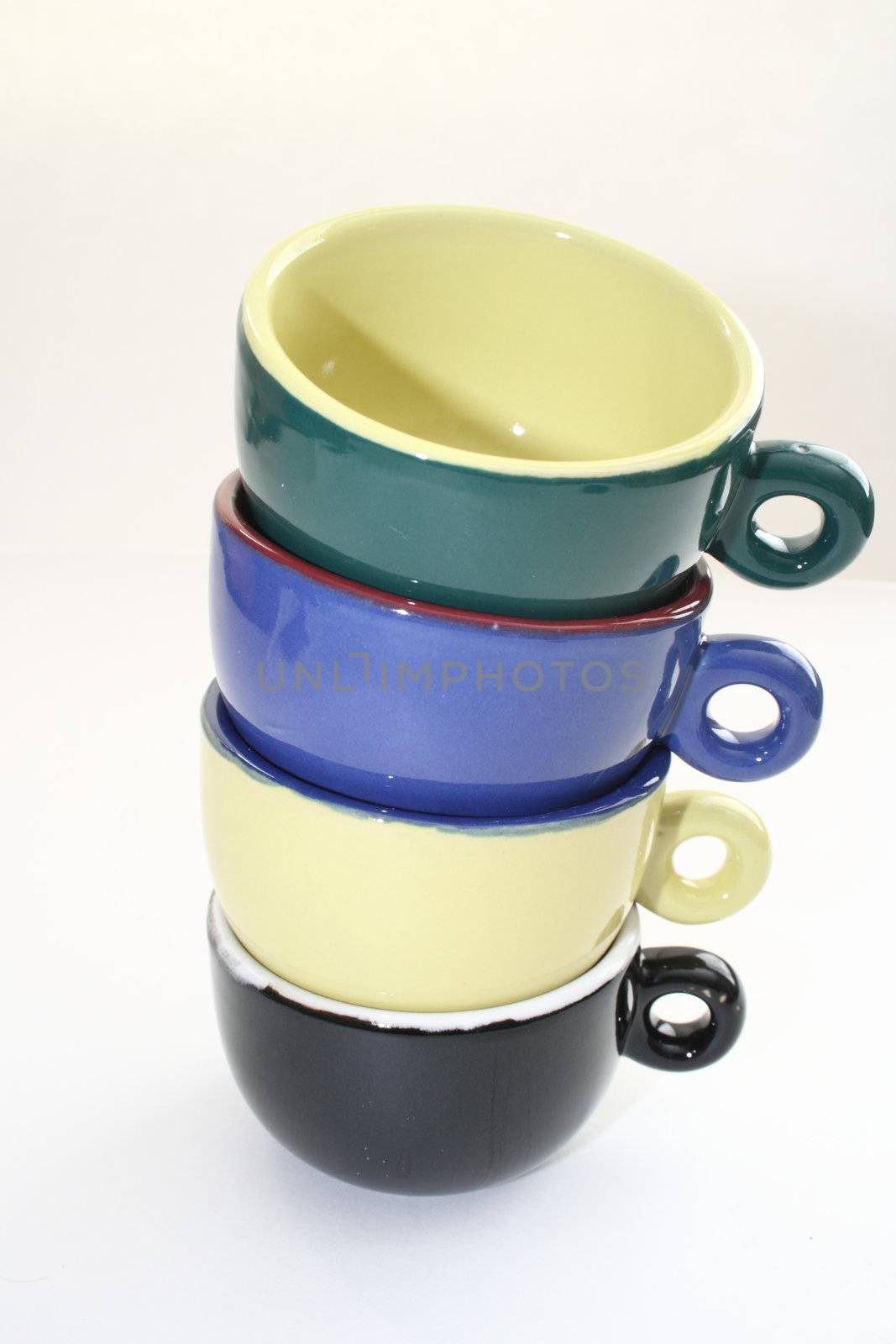 colorful coffee cups stacked on top of each other by njene