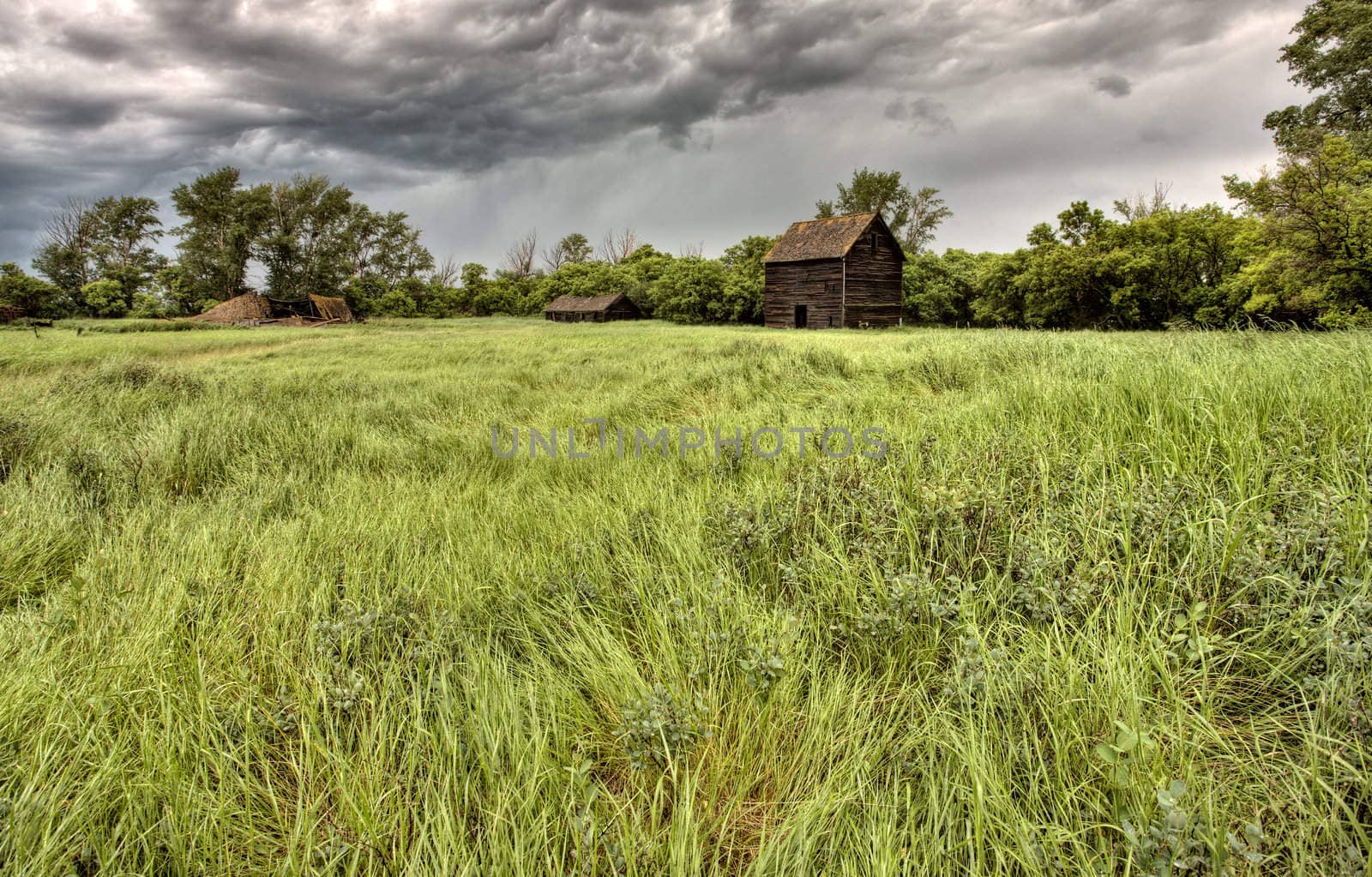 Abandoned Farm Buildings Saskatchewan Canada Storm clouds Prairie