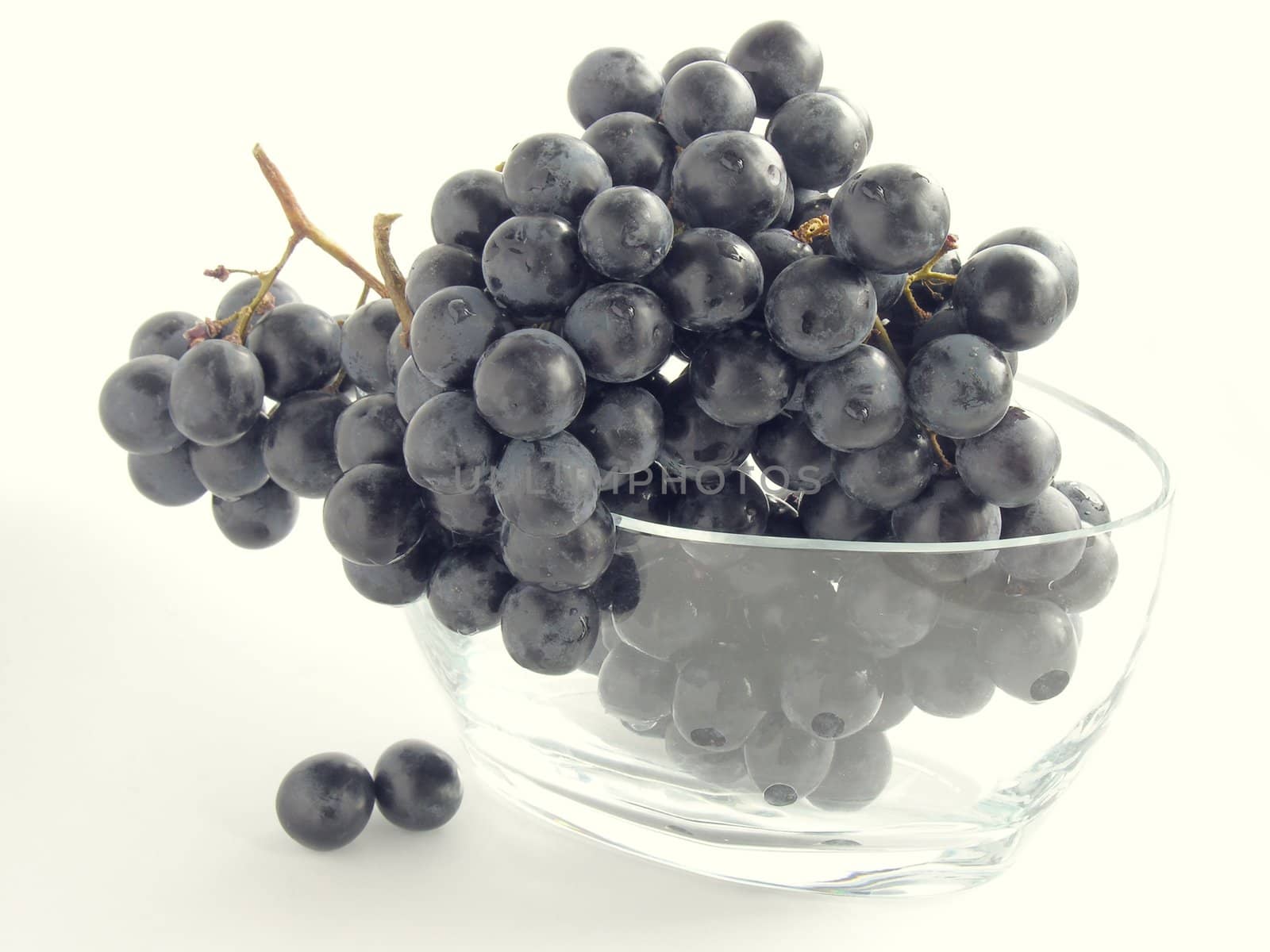 red grapes in glass pot by RAIMA