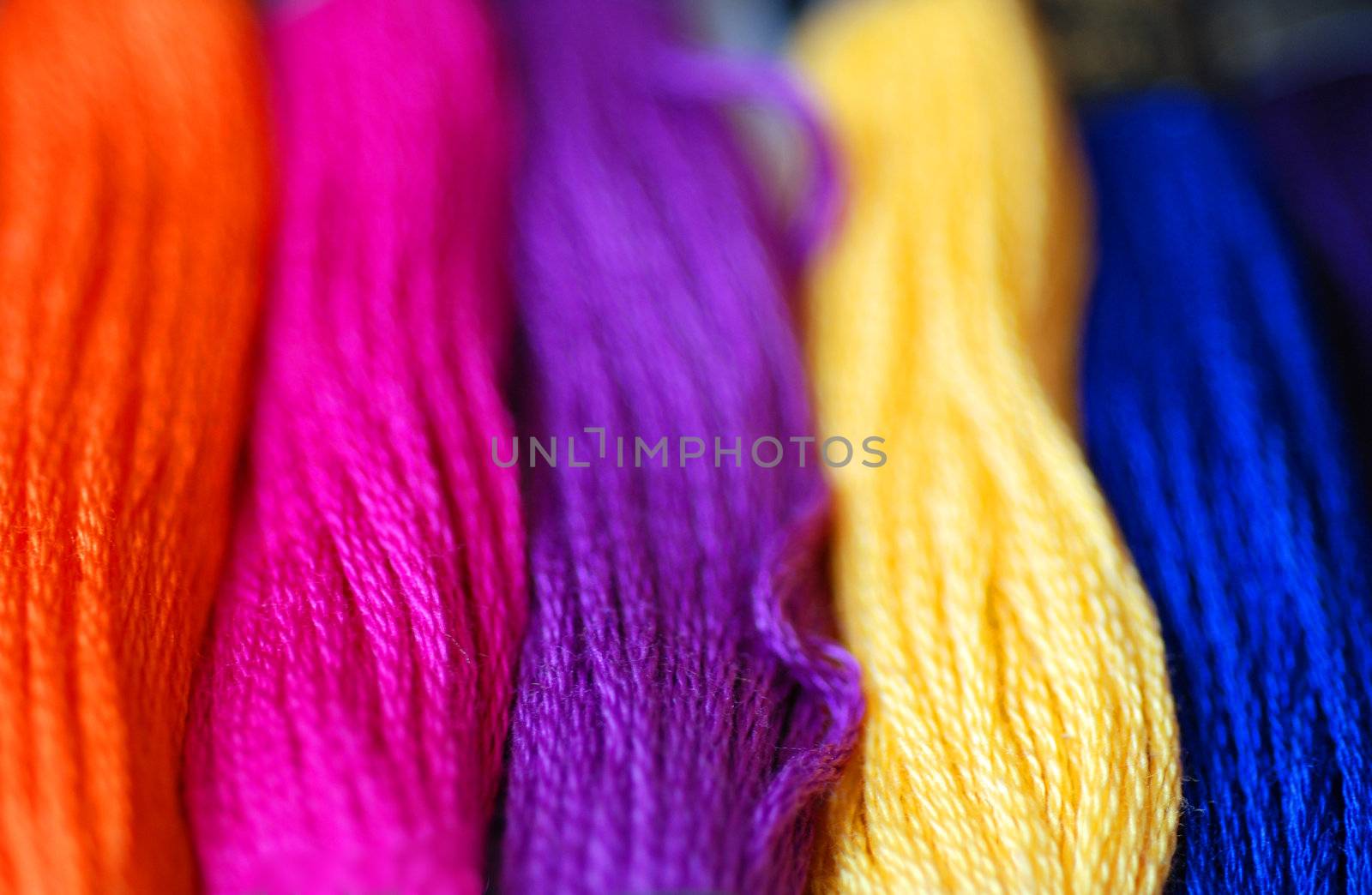 A close-up of bright and colourful sewing threads