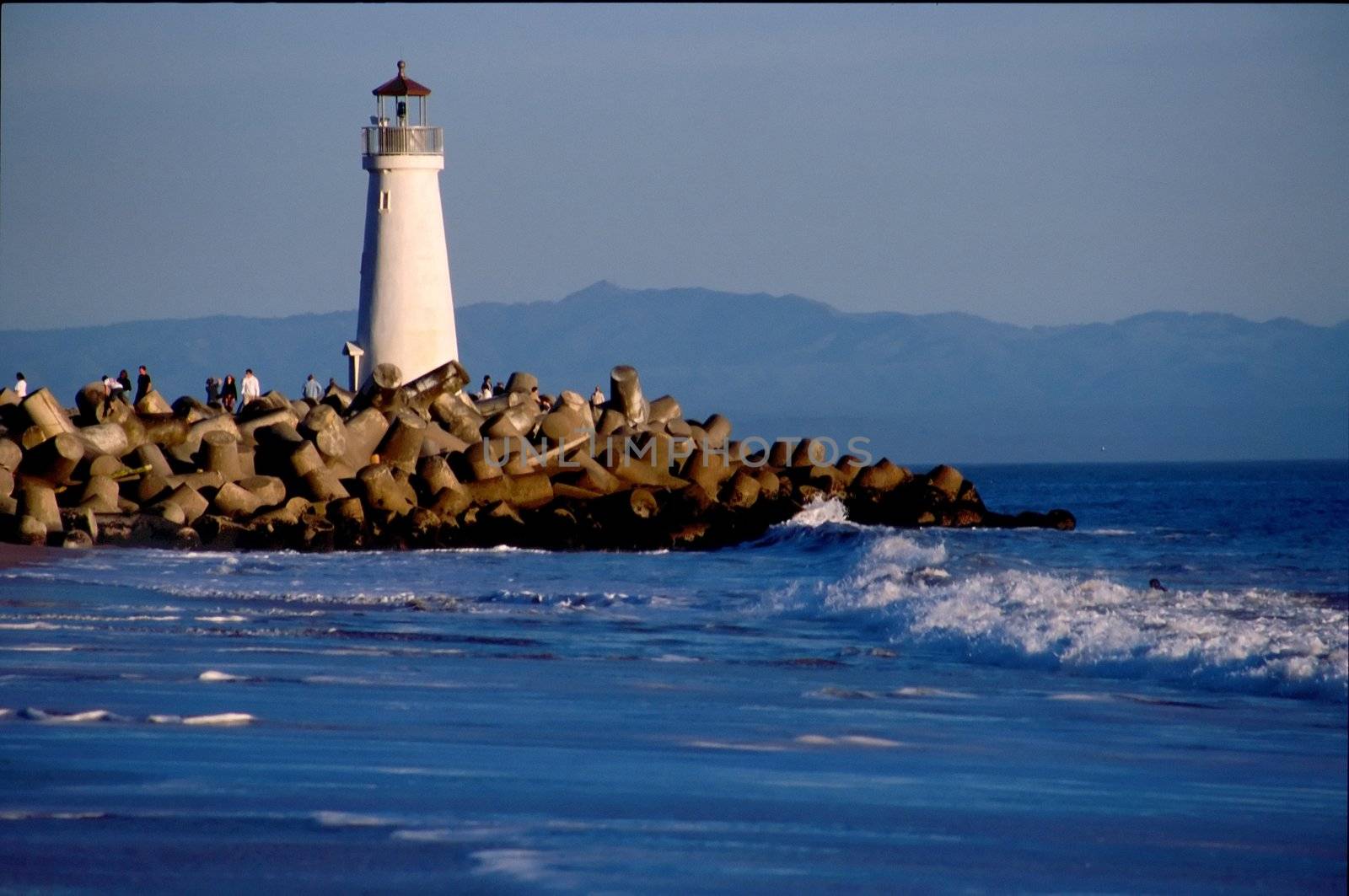 Santa Cruz Harbor - Located at the northern end of the Monterey Bay, the Santa Cruz Harbor is a haven for fishing craft and vessels. A harbor light, located at the west jetty, has marked its entrance for 40 years. The original light was a box light structure which served from 1964 � 1996. It was replaced by a cylinder nicknamed �the water heater� which was used from 1996 � 1999. From 1999 until May 2002, a simple pipe structure held the light which marked the way.