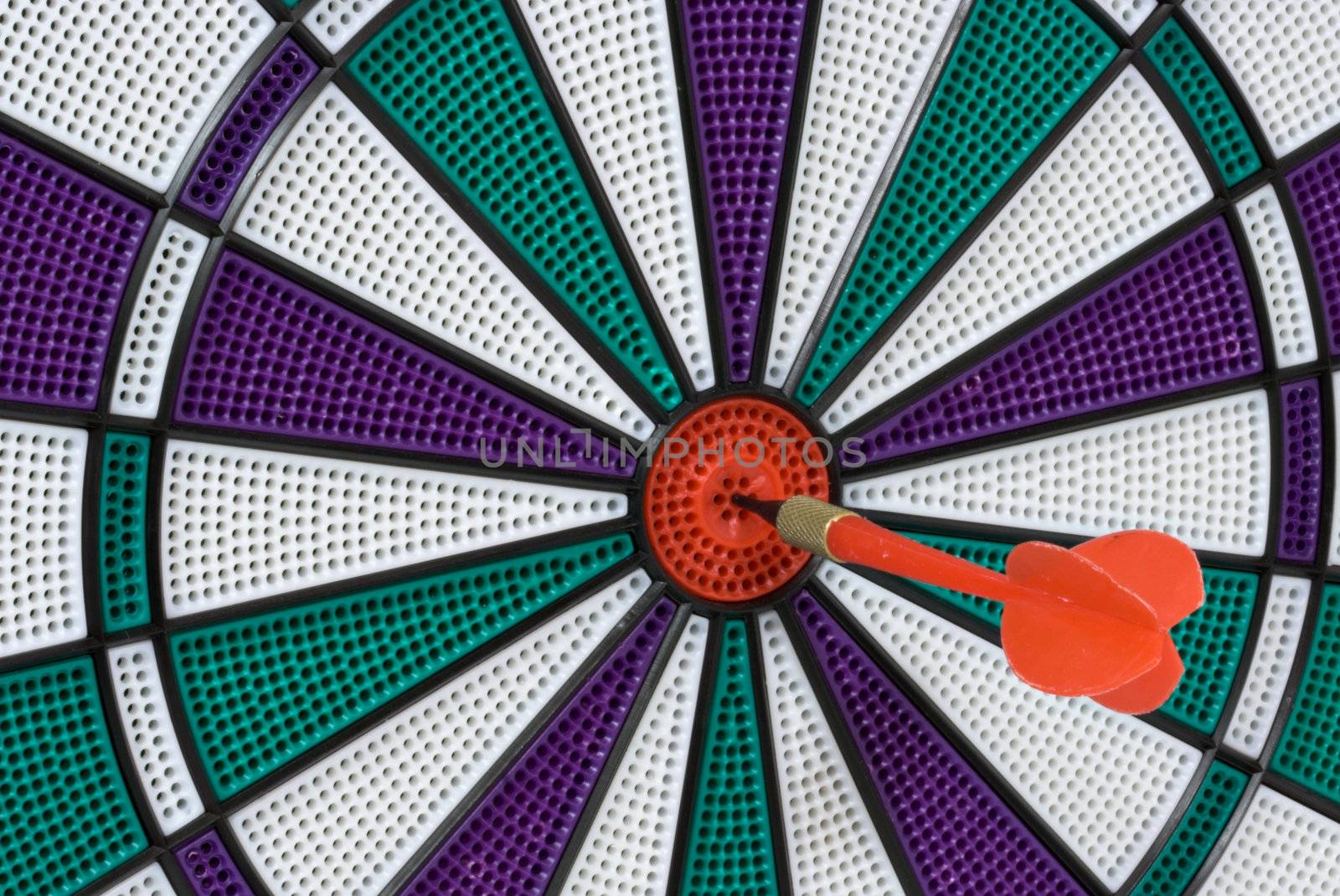 Dartboard with dart in center (bullseye)