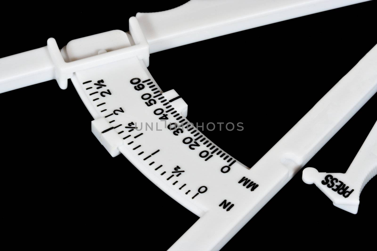 Body fat calipers isolated over a black background