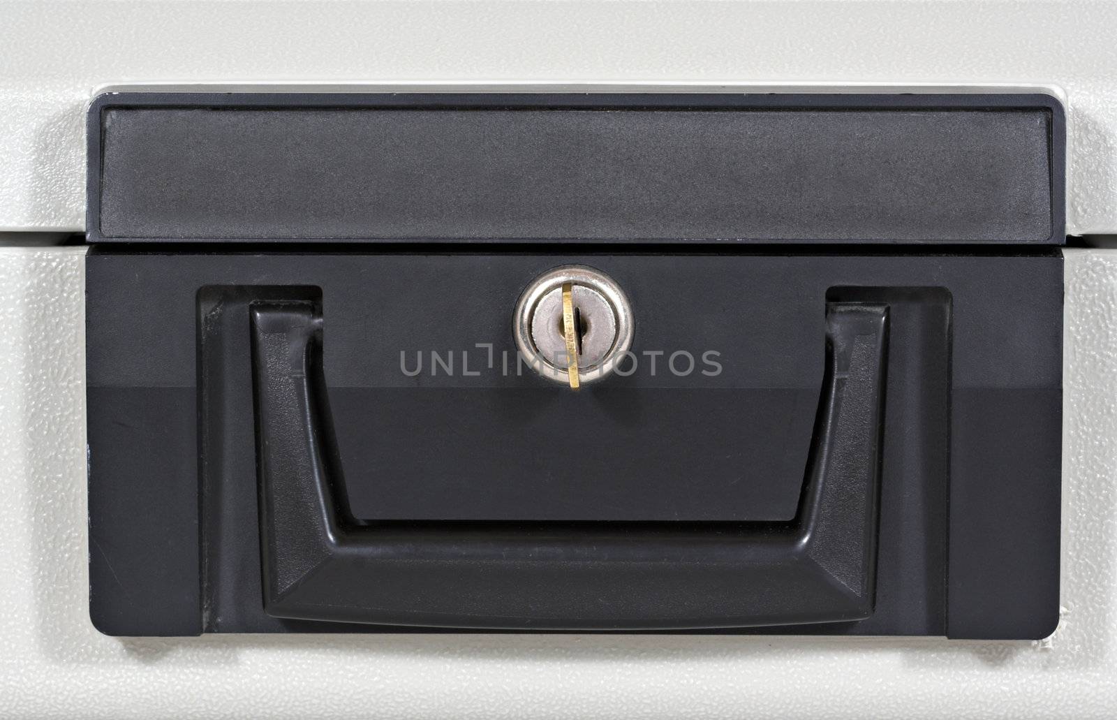 Front of a fire proof lock box with key in keyhole