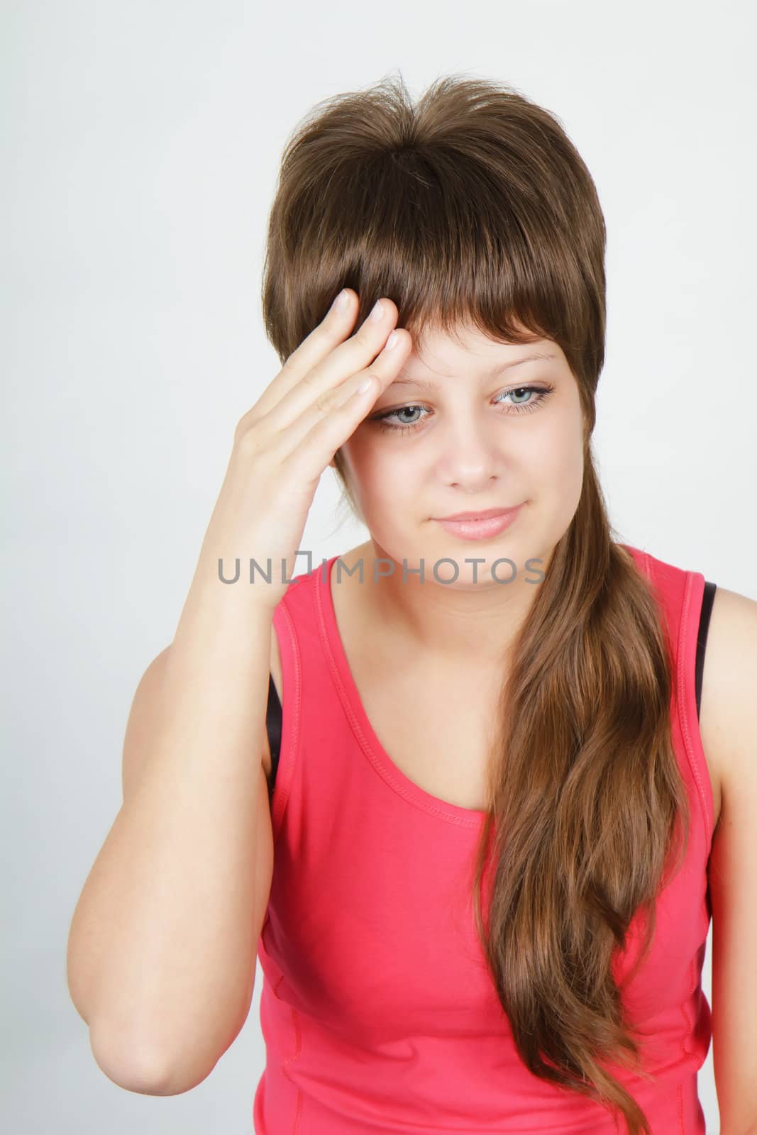 young attractive girl with a headache on a light background