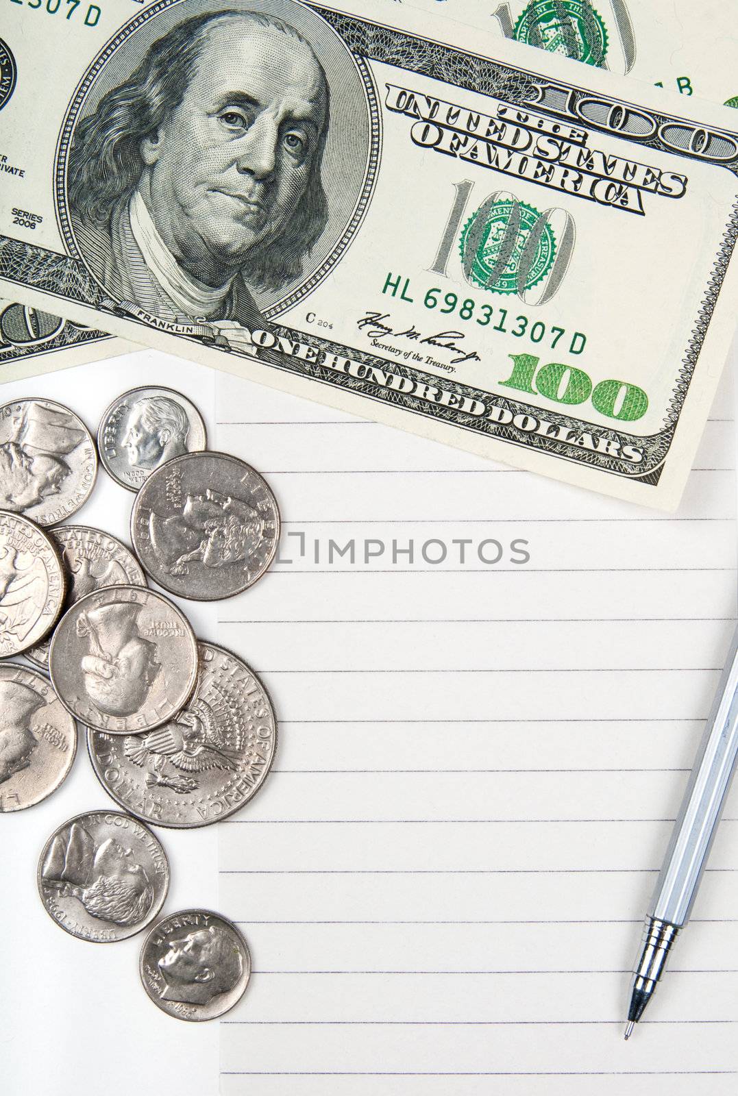 Empty lined paper to white a shopping list, money and pen.