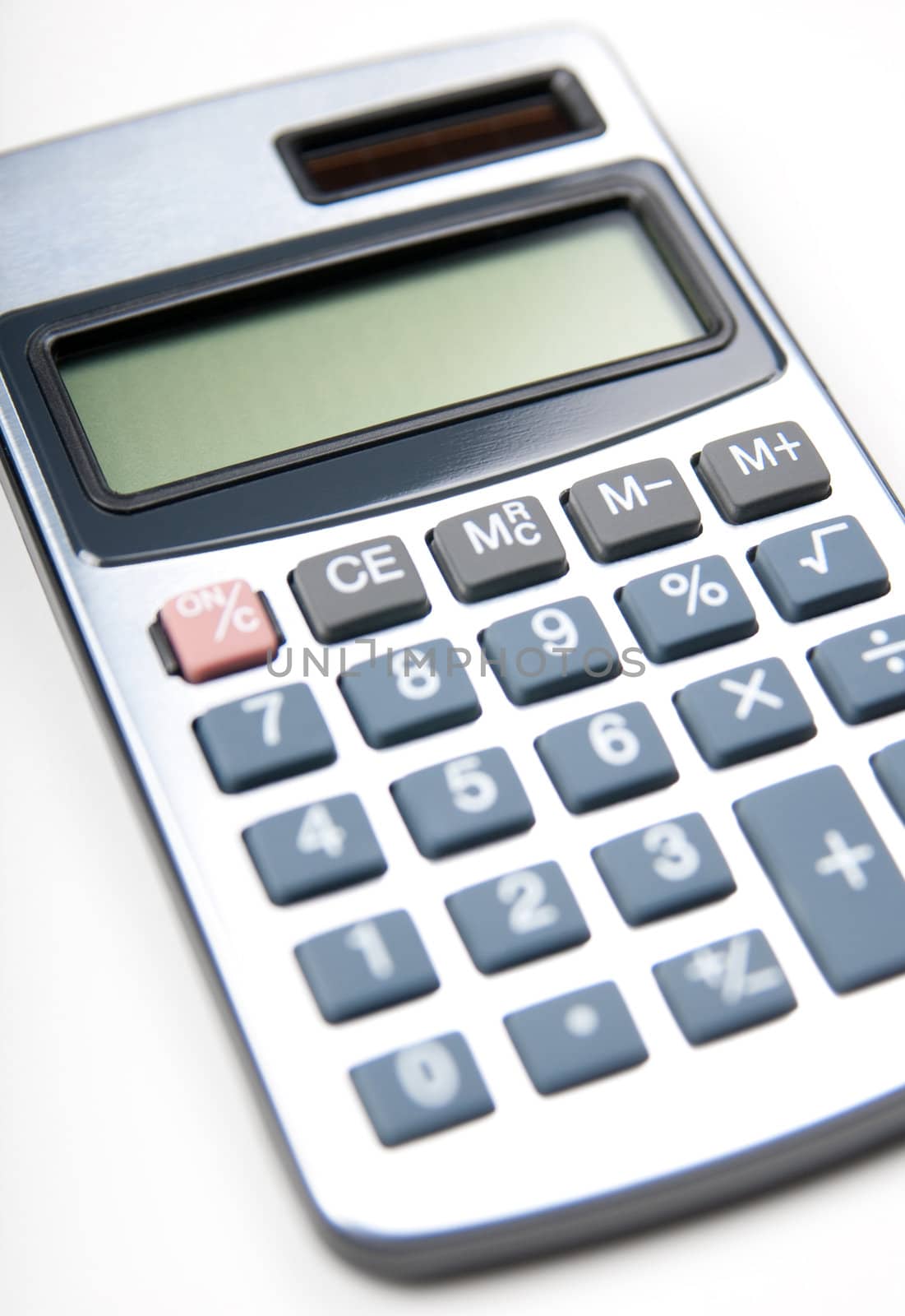 Silver calculator on white background. Shallow depth of field.