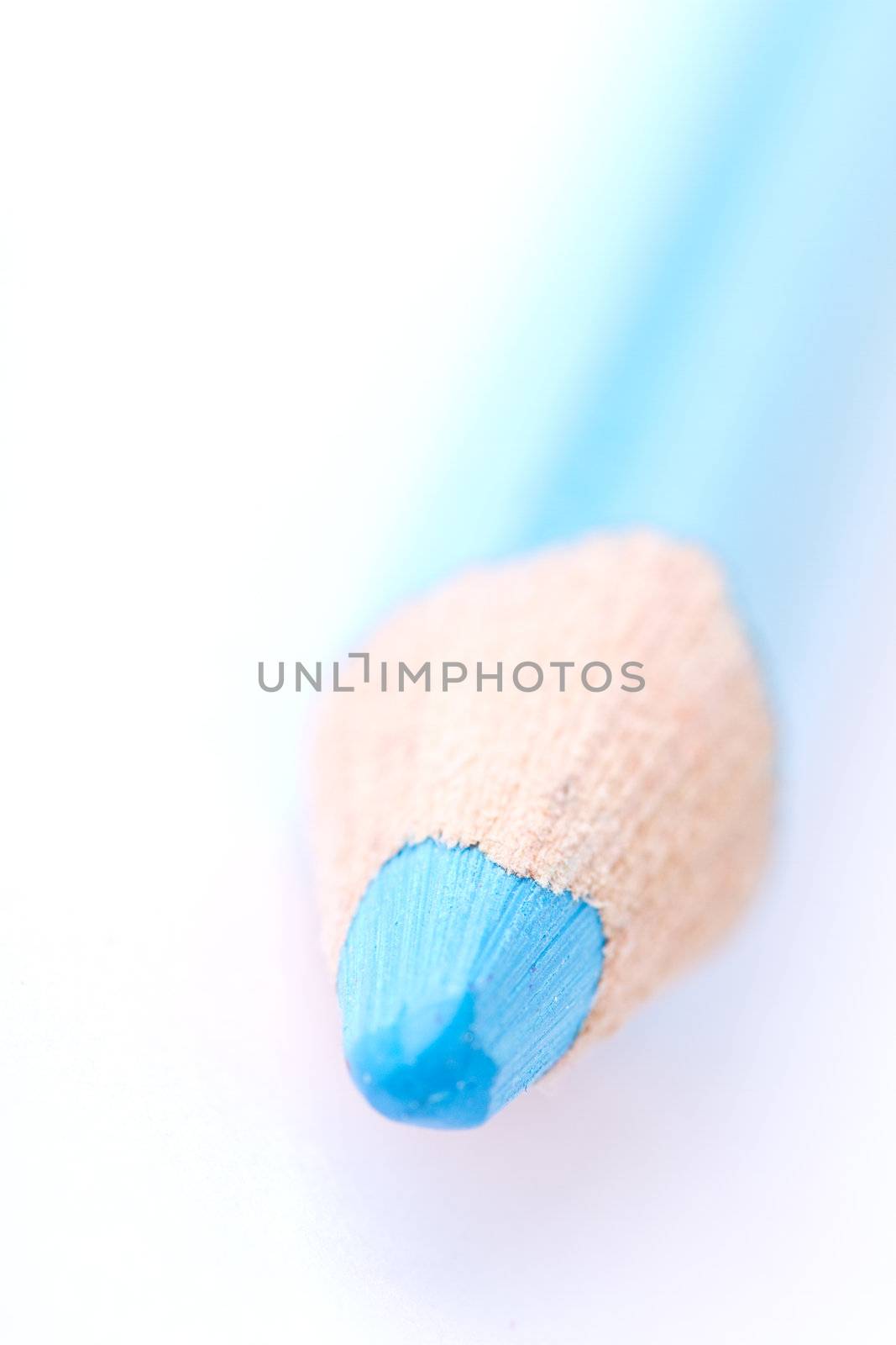 Closeup of a blue crayon isolated on a white backgrund. Has a shallow depth of field.