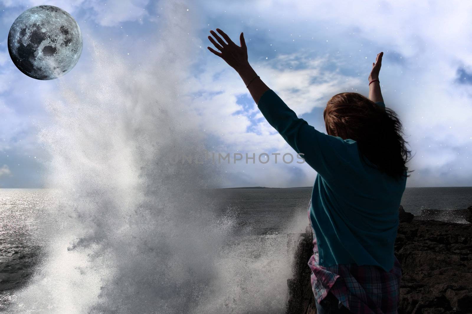 lone woman with raised hands facing a wave and full moon on clif by morrbyte