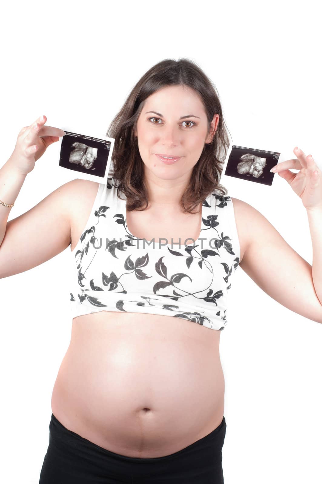 Happy young woman holding a sonogram of her child