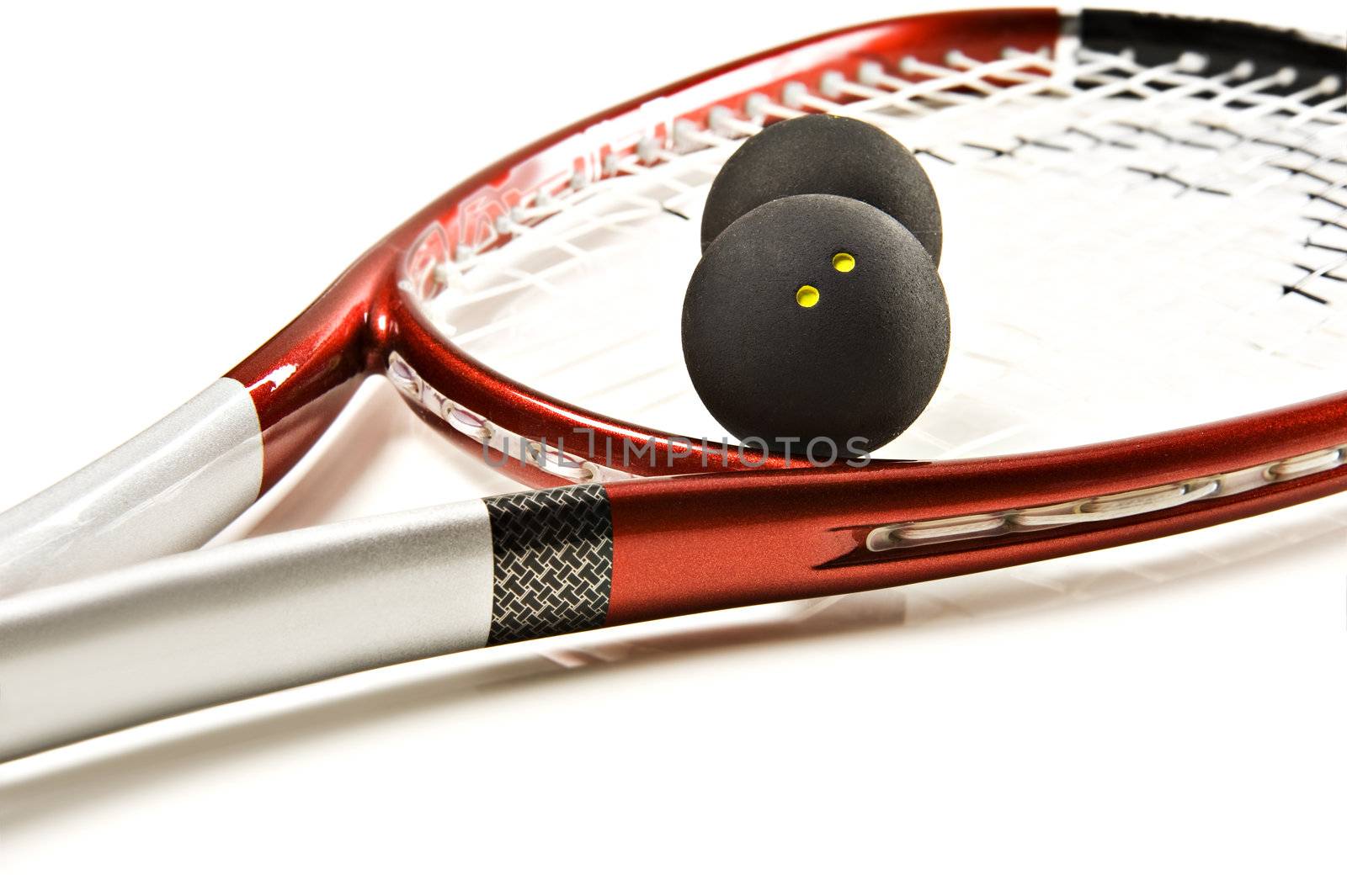 Close up of a squash racket and balls