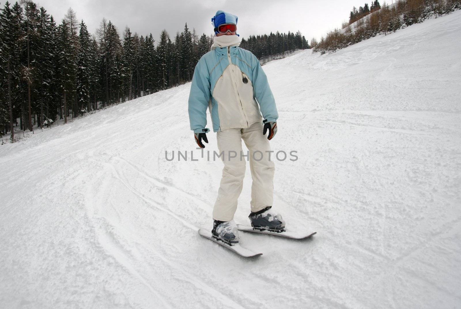 Girl coming down the slope on snowblades