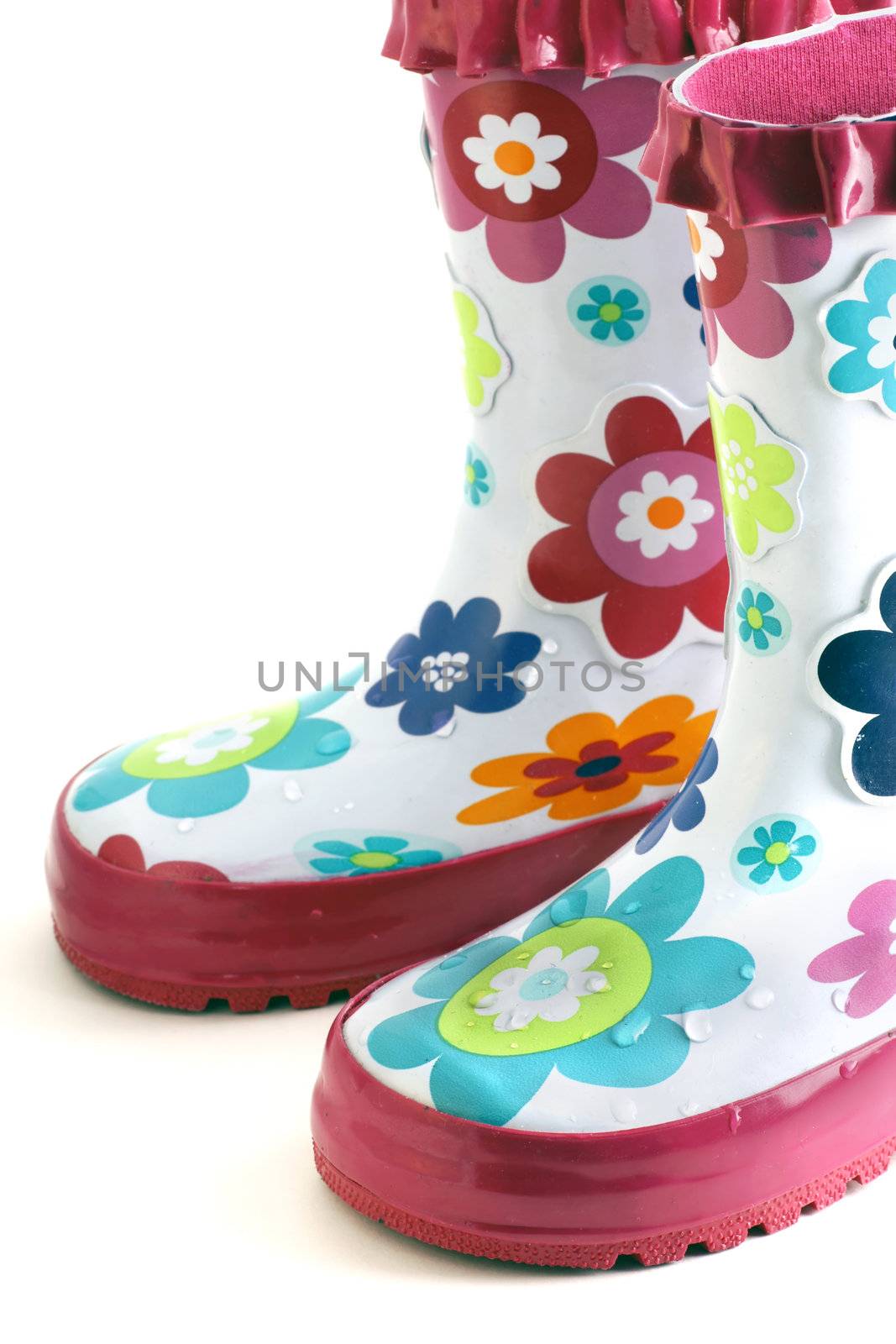 Fun little girl's colorful flower rain boots isolated on white.