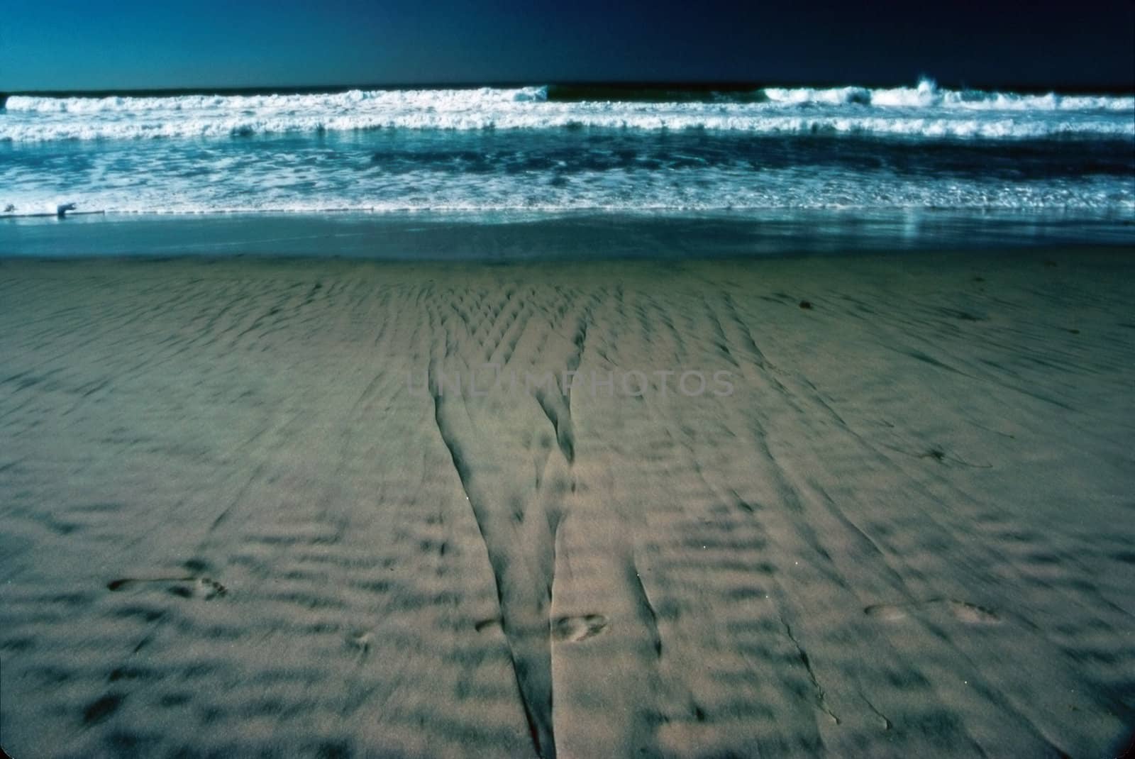 Beach with foot prints in sand