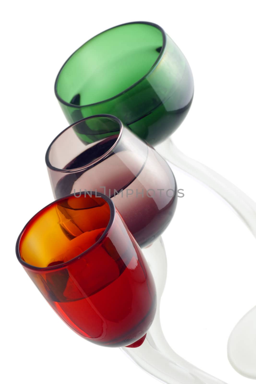 Three hand crafted beautiful colorful cocktail glasses.