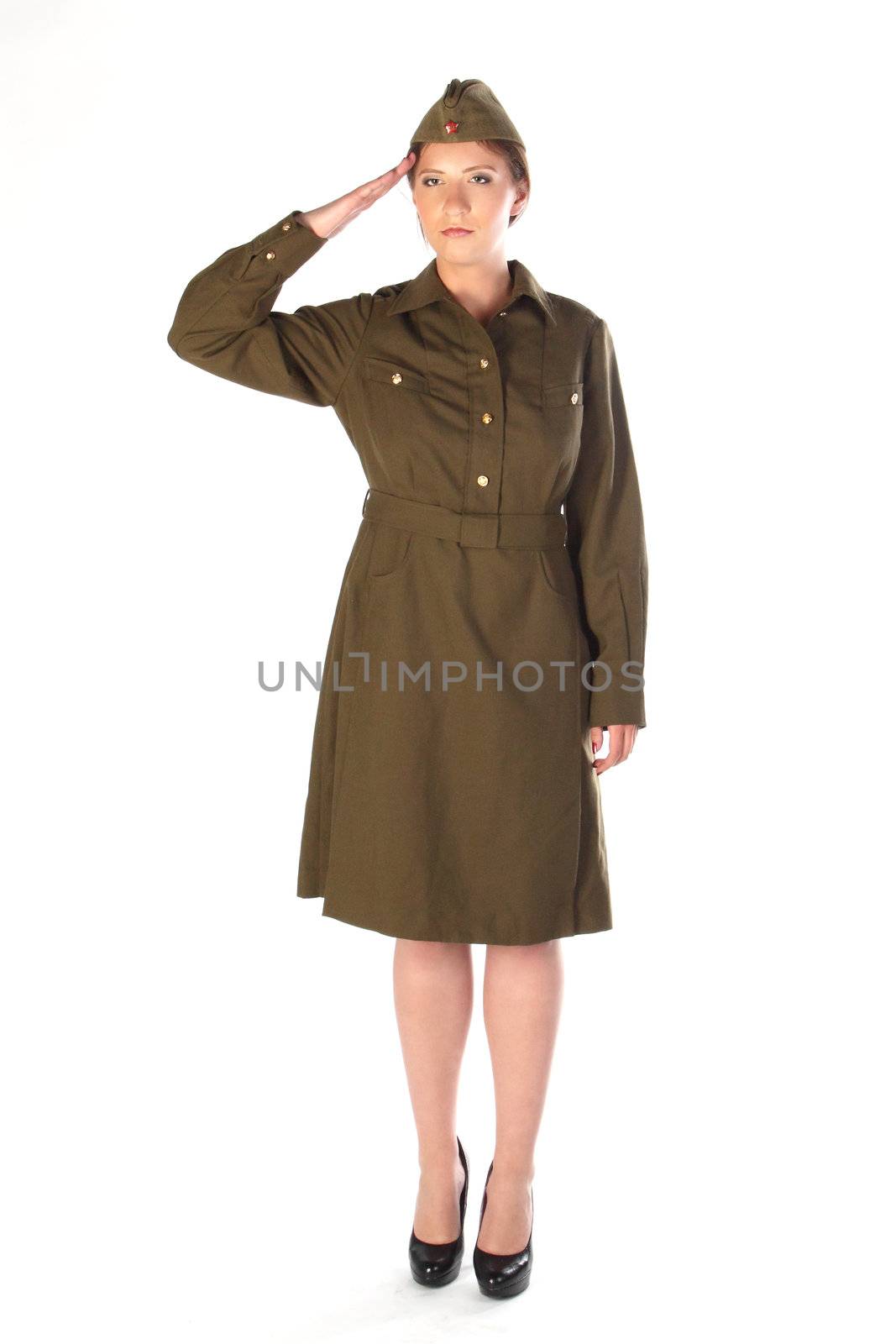 The young and beautiful girl in a military dress and a field cap