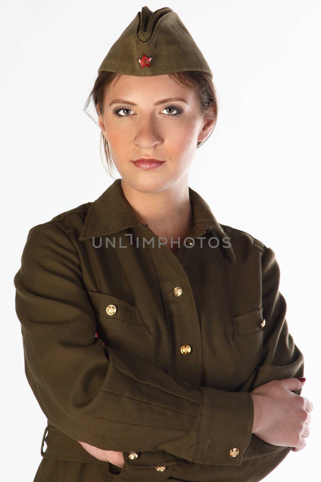 The young and beautiful girl in a military dress and a field cap