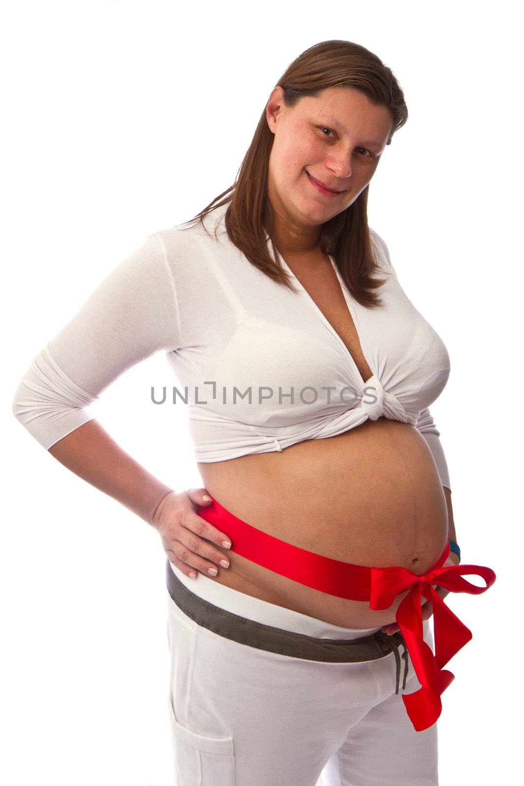 Pregnant woman with red ribbon on belly isolated on white