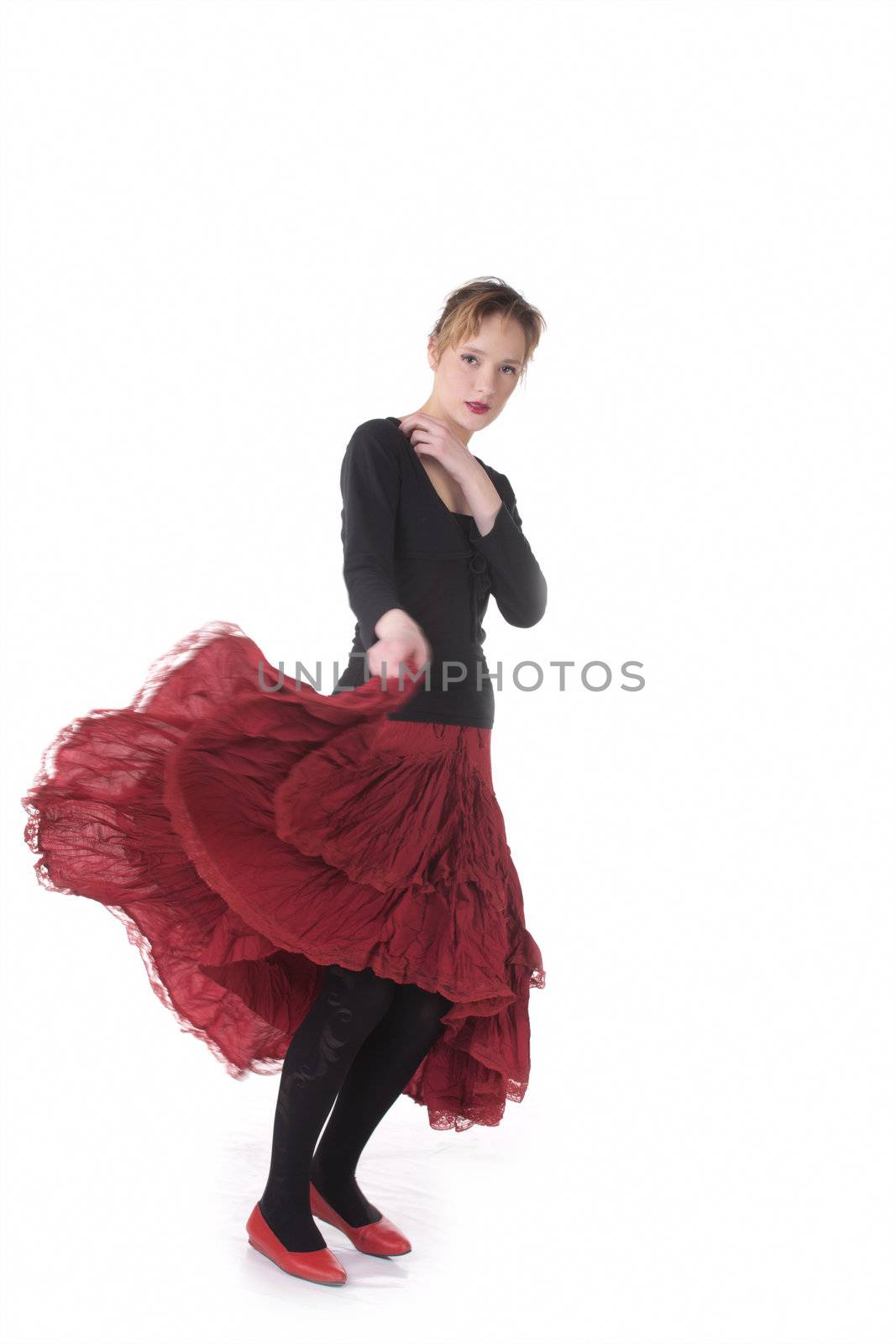 Dansing girl in red and black in studio over white