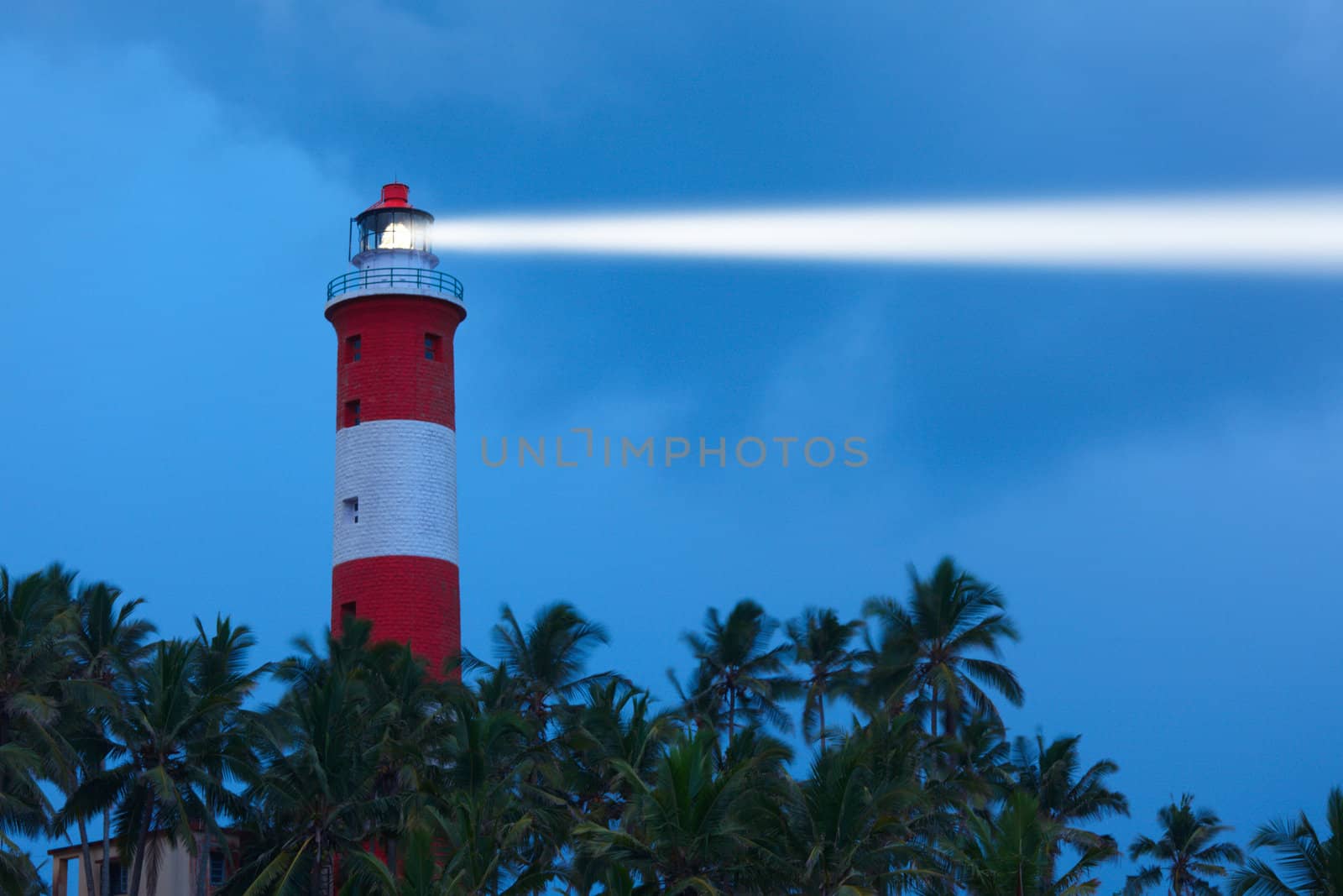 Lighthouse in night with light beam by dimol