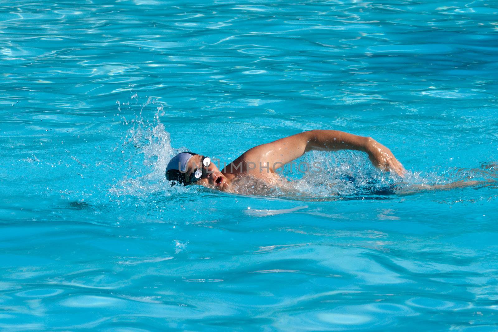 Athletic Man swimming in the pool