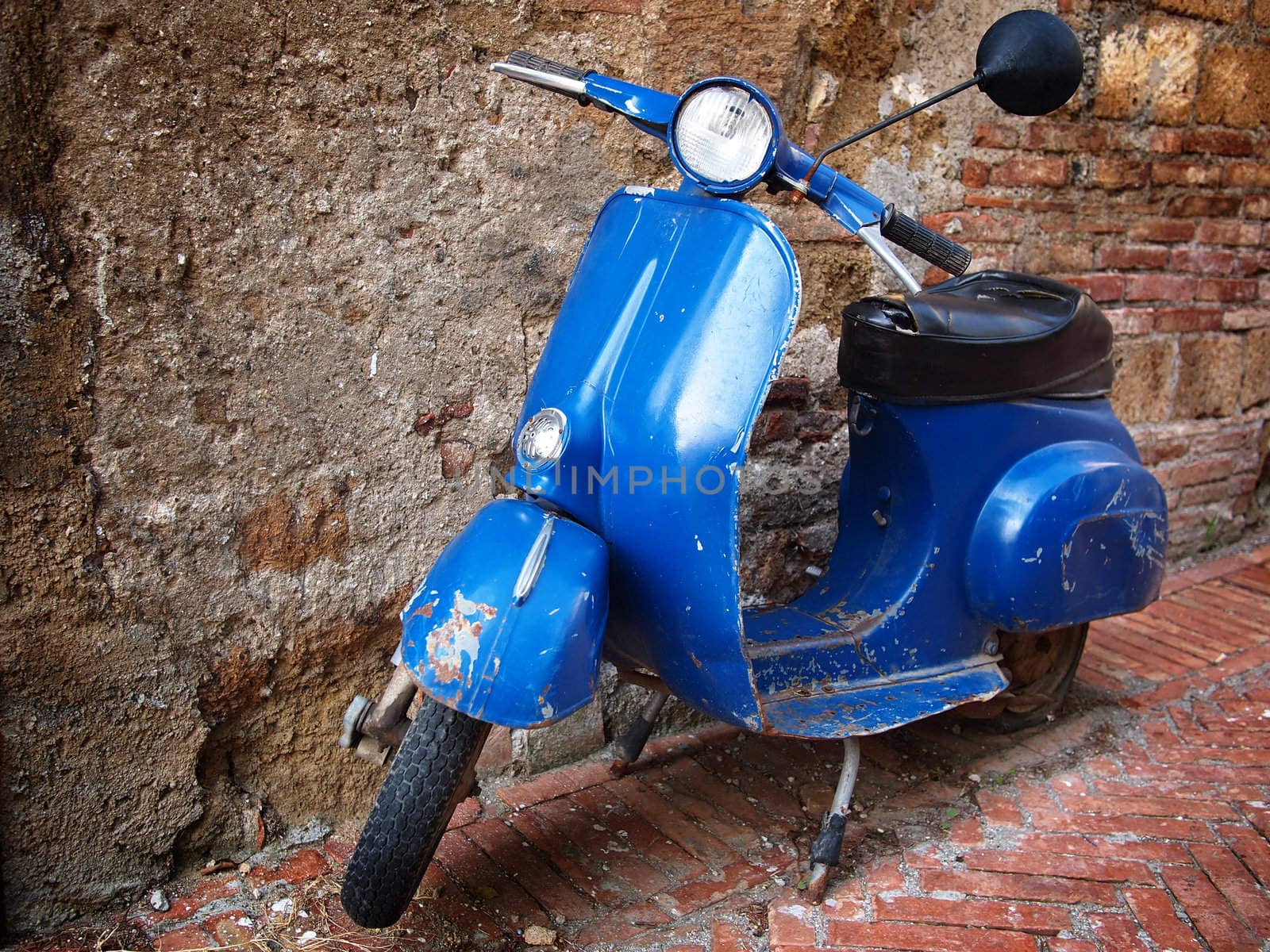 Vintage scooter in front of a brick wall by pljvv
