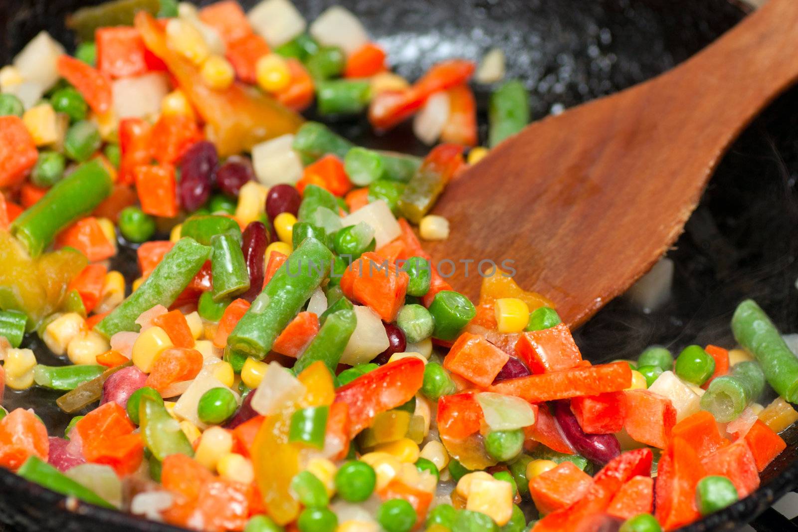 Chopped vegetables frying on a frying pan