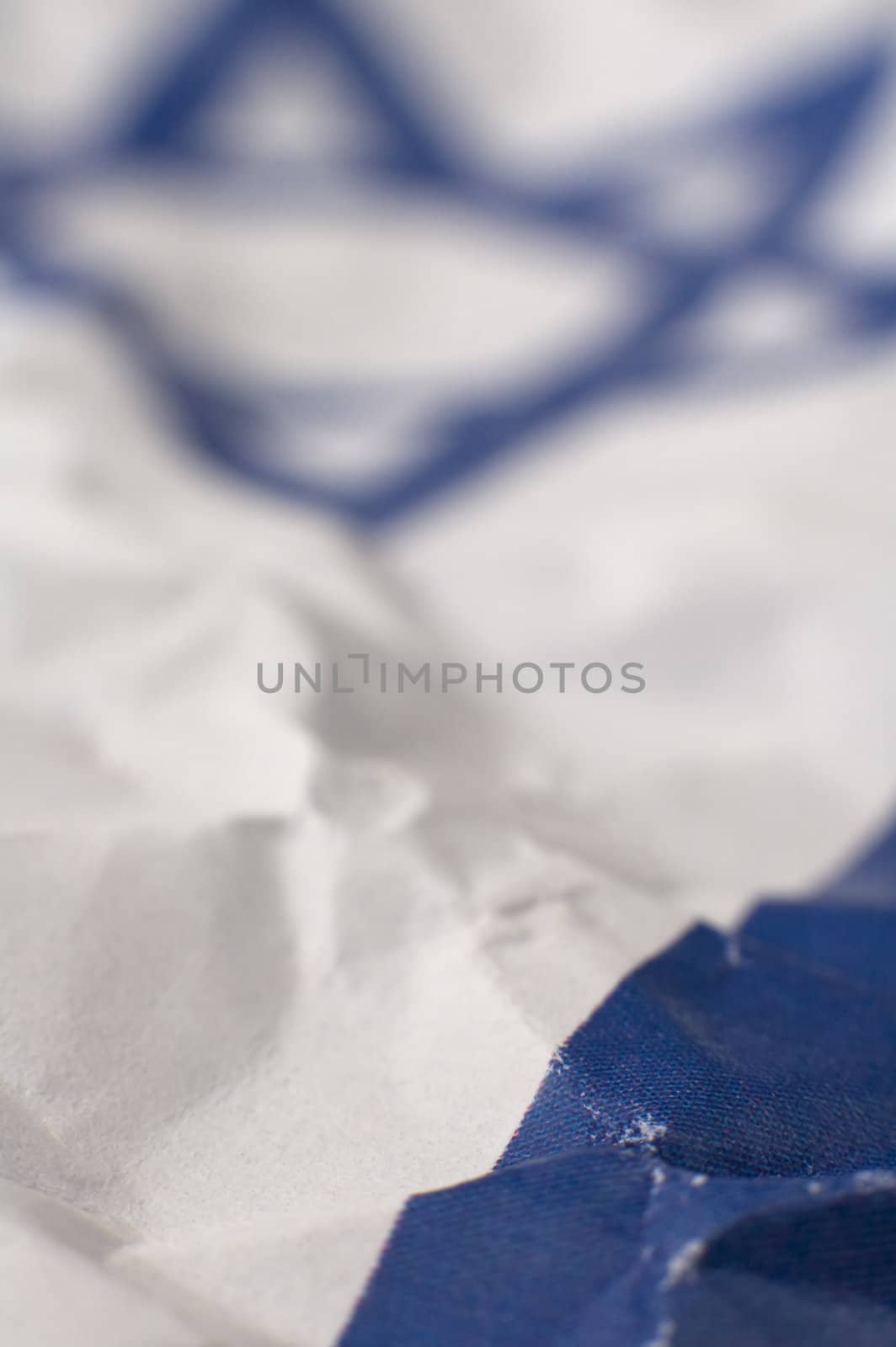 abstract conceptual photo of israel flag, david star blurred in background, only small portion in focus