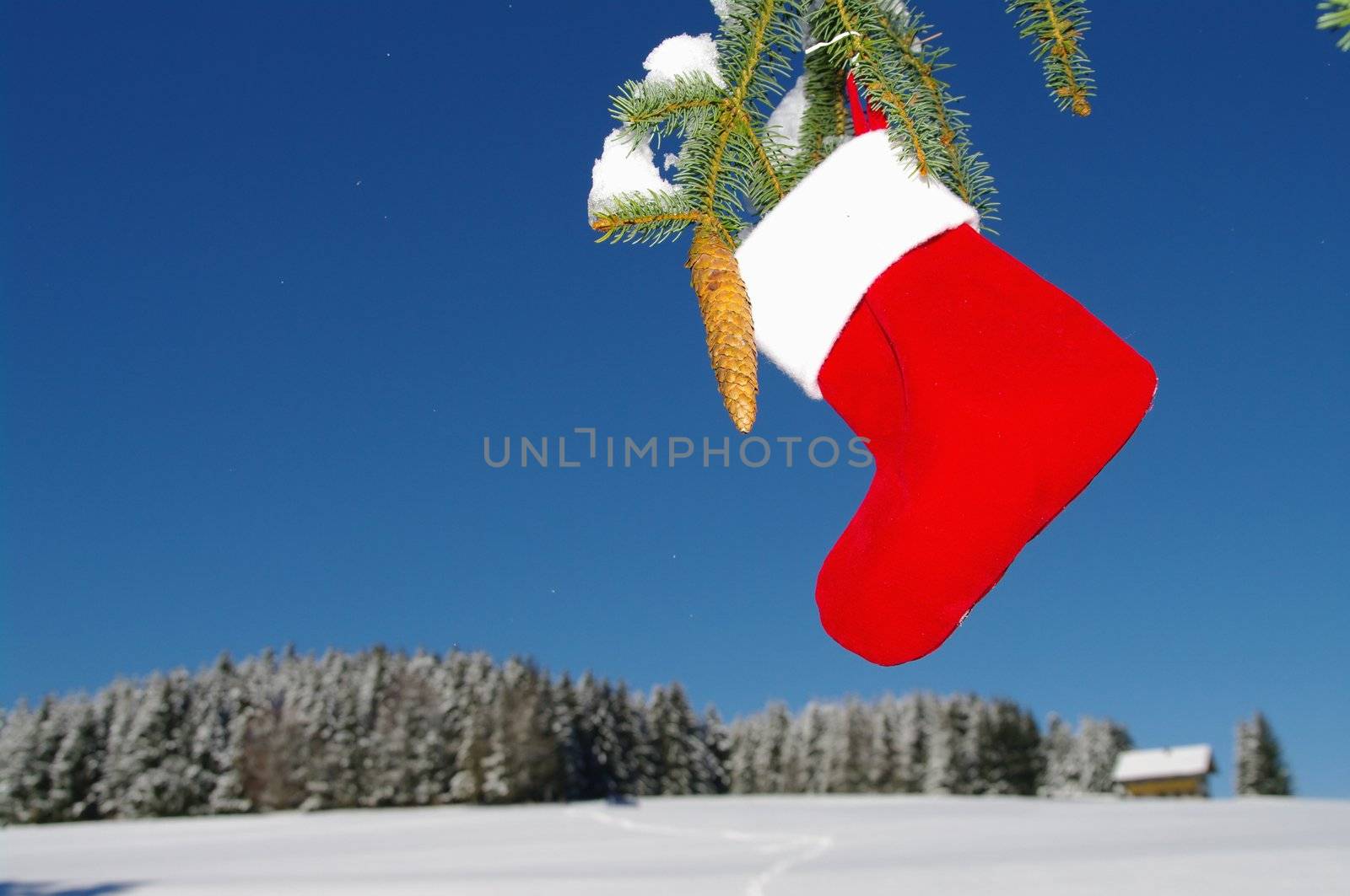 Santa Claus Christmas boot for gifts outside in a snowy landscape