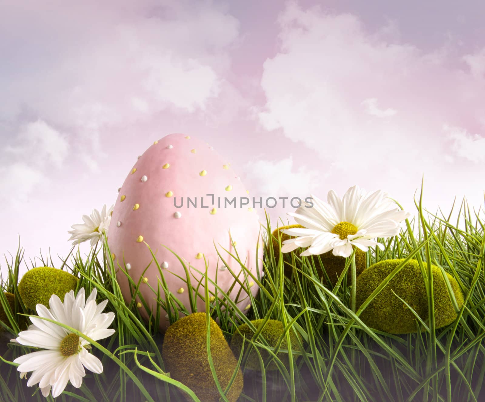 Large pink easter with flowers in tall grass with sky 