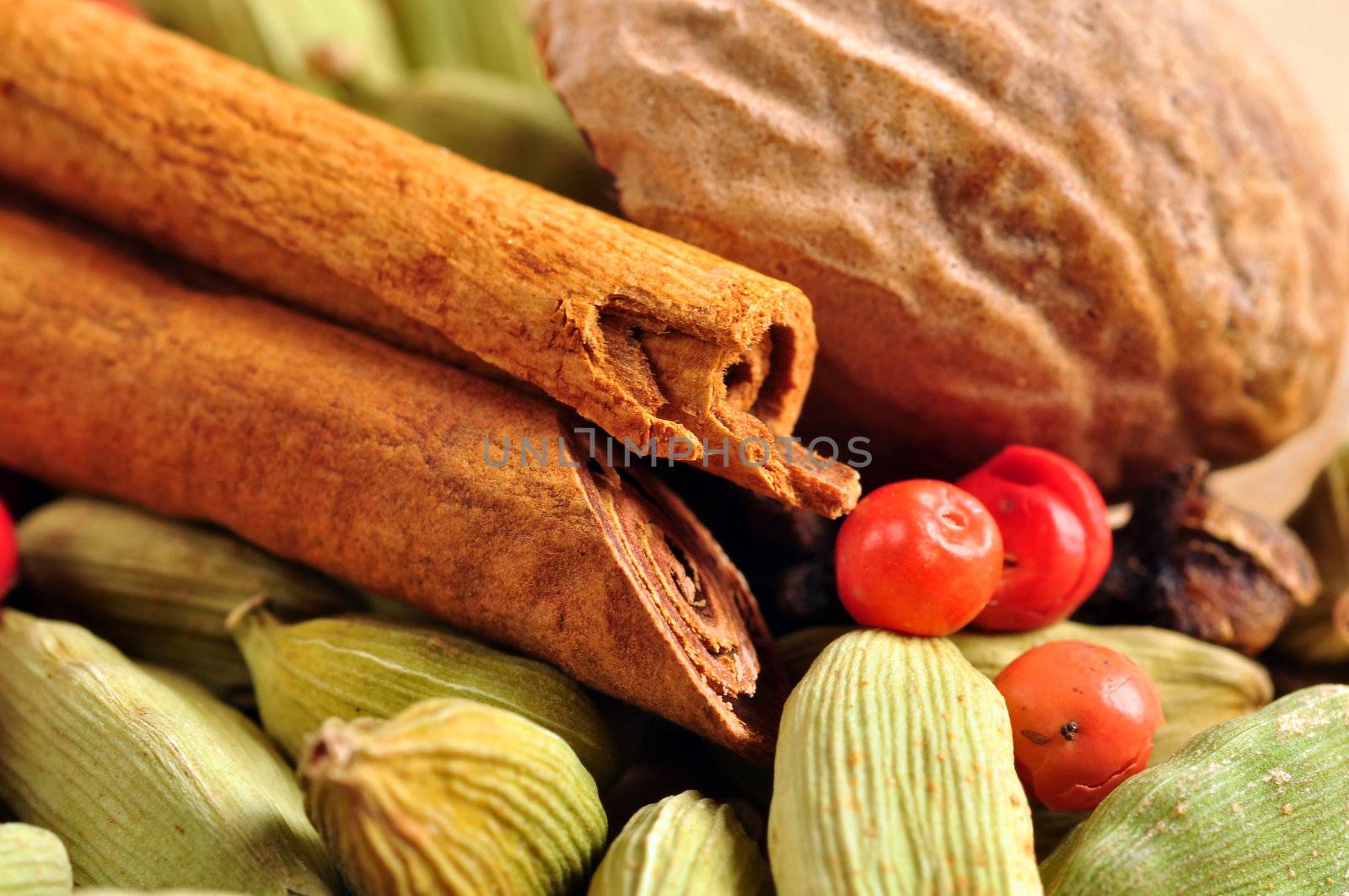 Beautiful arrangement of whole natural colorful spices, cinnamon, cardamom, nutmeg, pink pepper and clove.