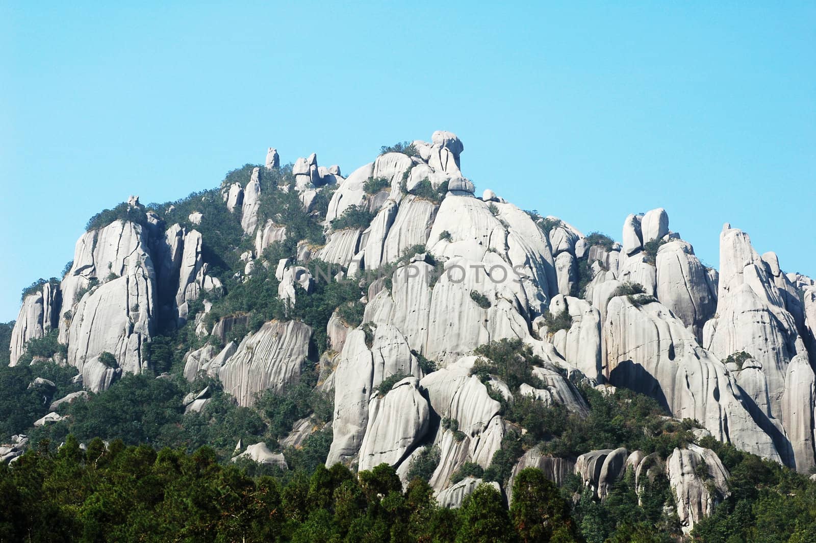 Landscape of rocky mountains with blue sky as background