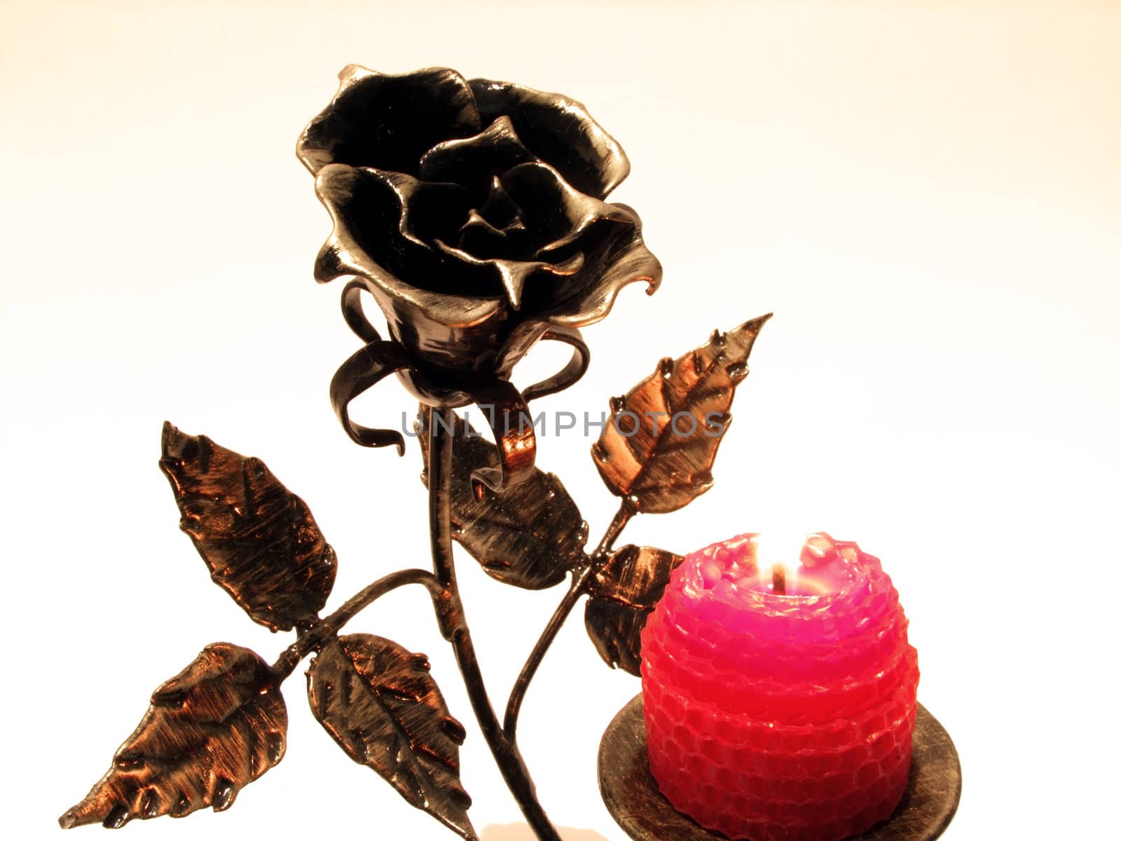metallic candle with a rose and a candle
