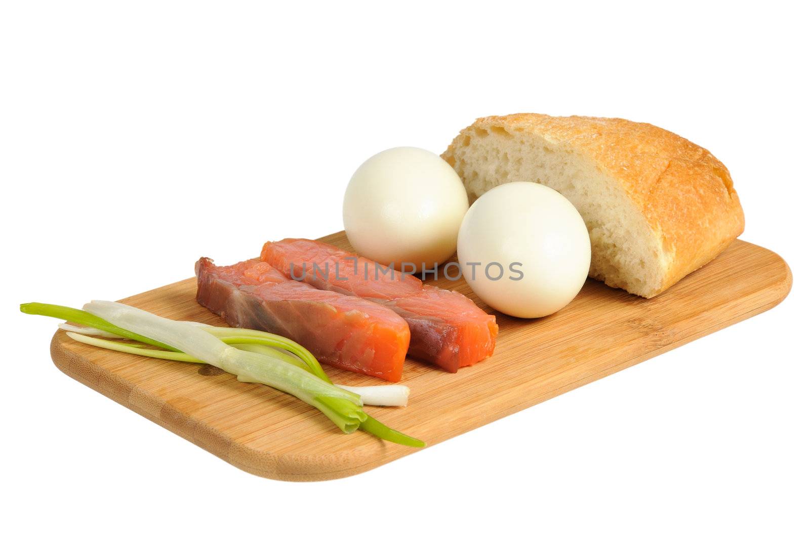 Light breakfast. Eggs, salted salmon, muffin and onion on a wooden board. Isolated on white.