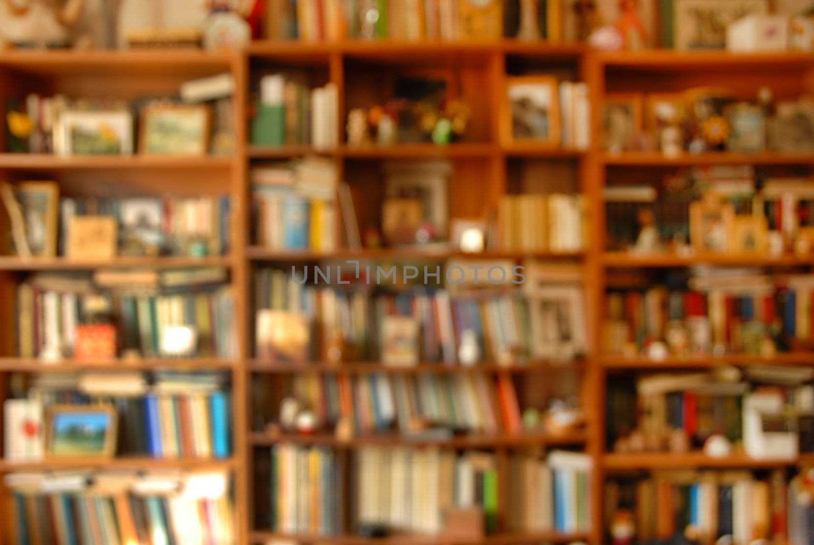 blur wooden bookshelves with various colorful books background