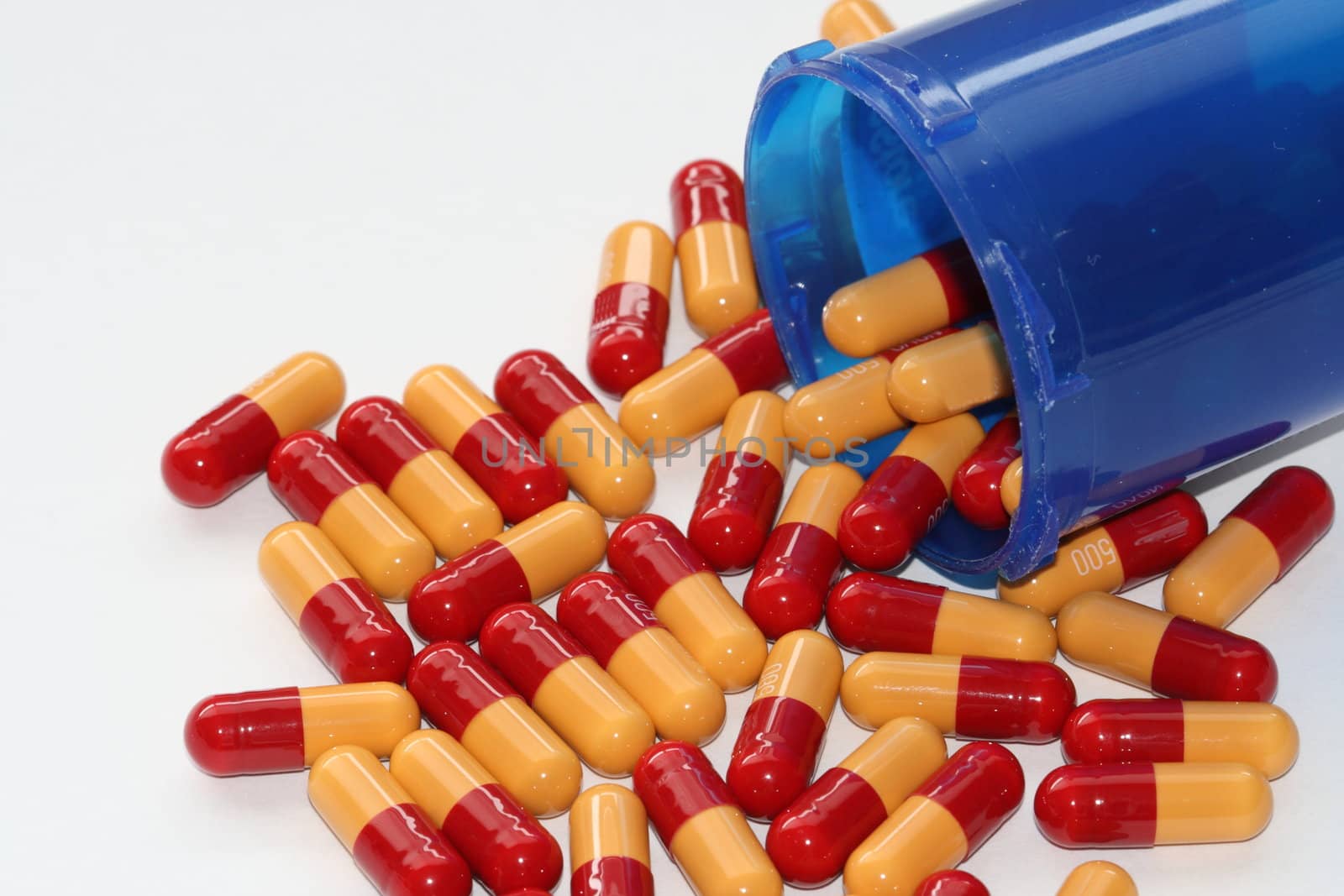 prescription drugs spilling out of an open container by njene