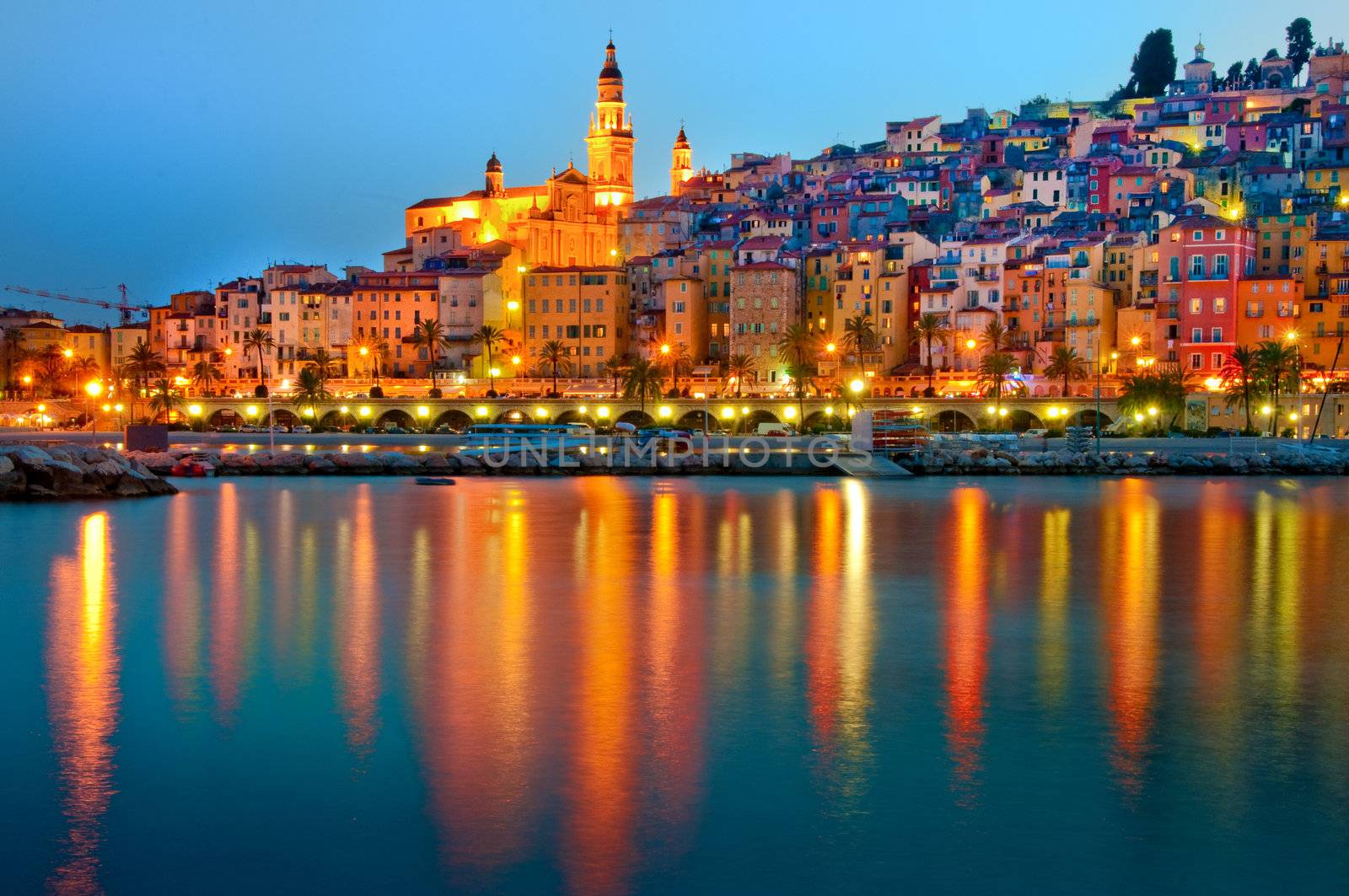 Menton Provence village at night with water reflection