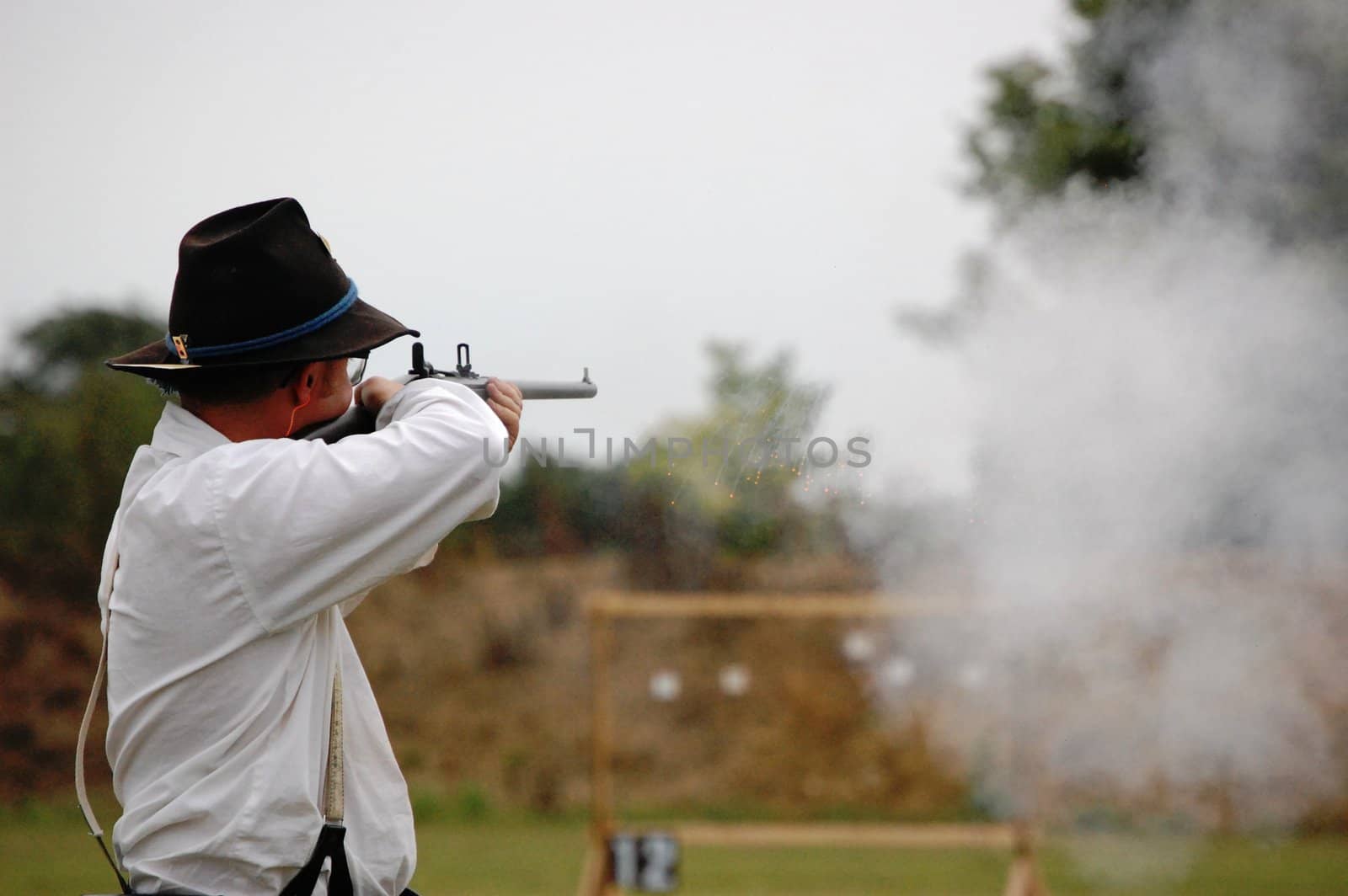 Man shoots carbine sparks fly by RefocusPhoto