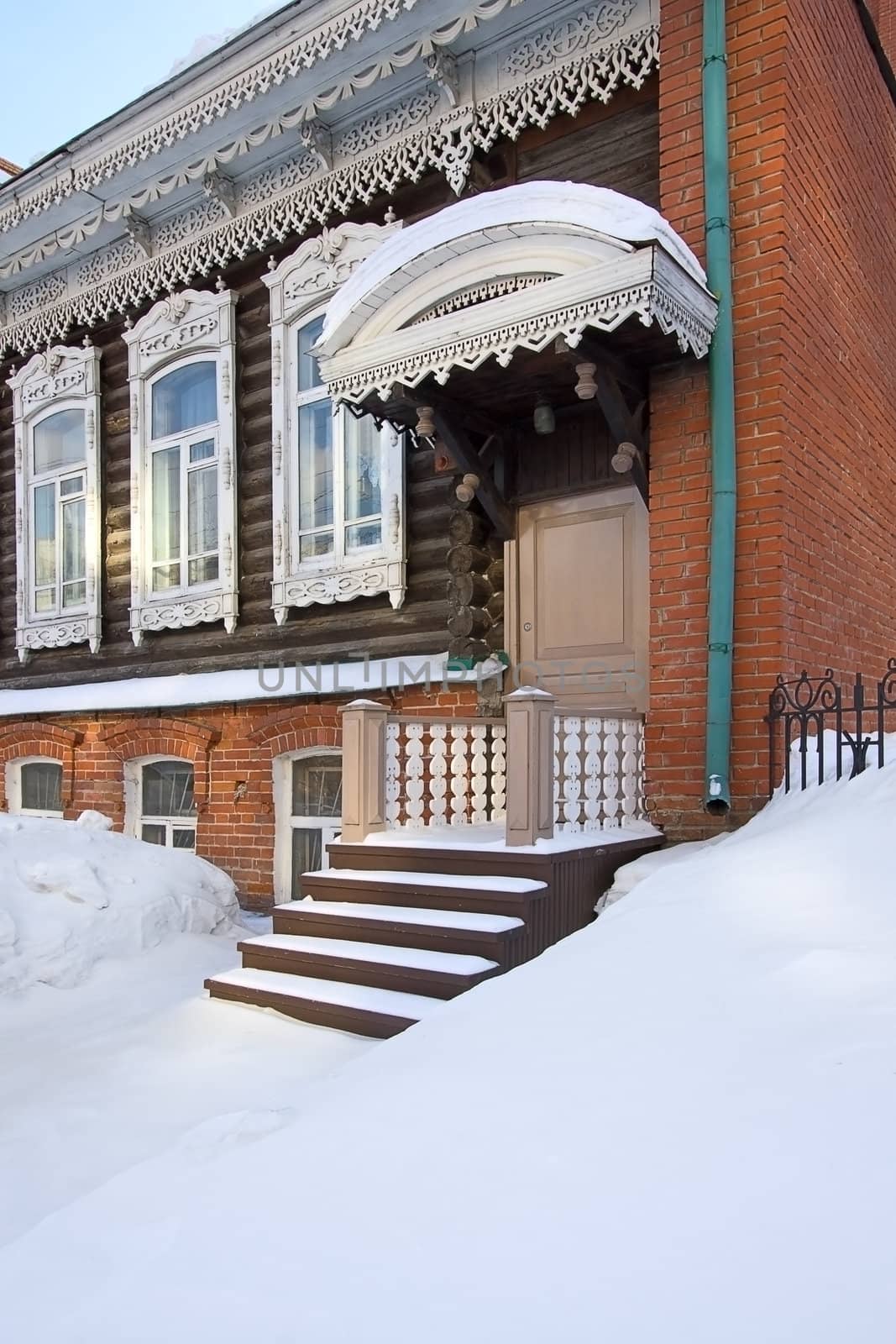 Winter. Snow lies on  porch of  old house, Russia.