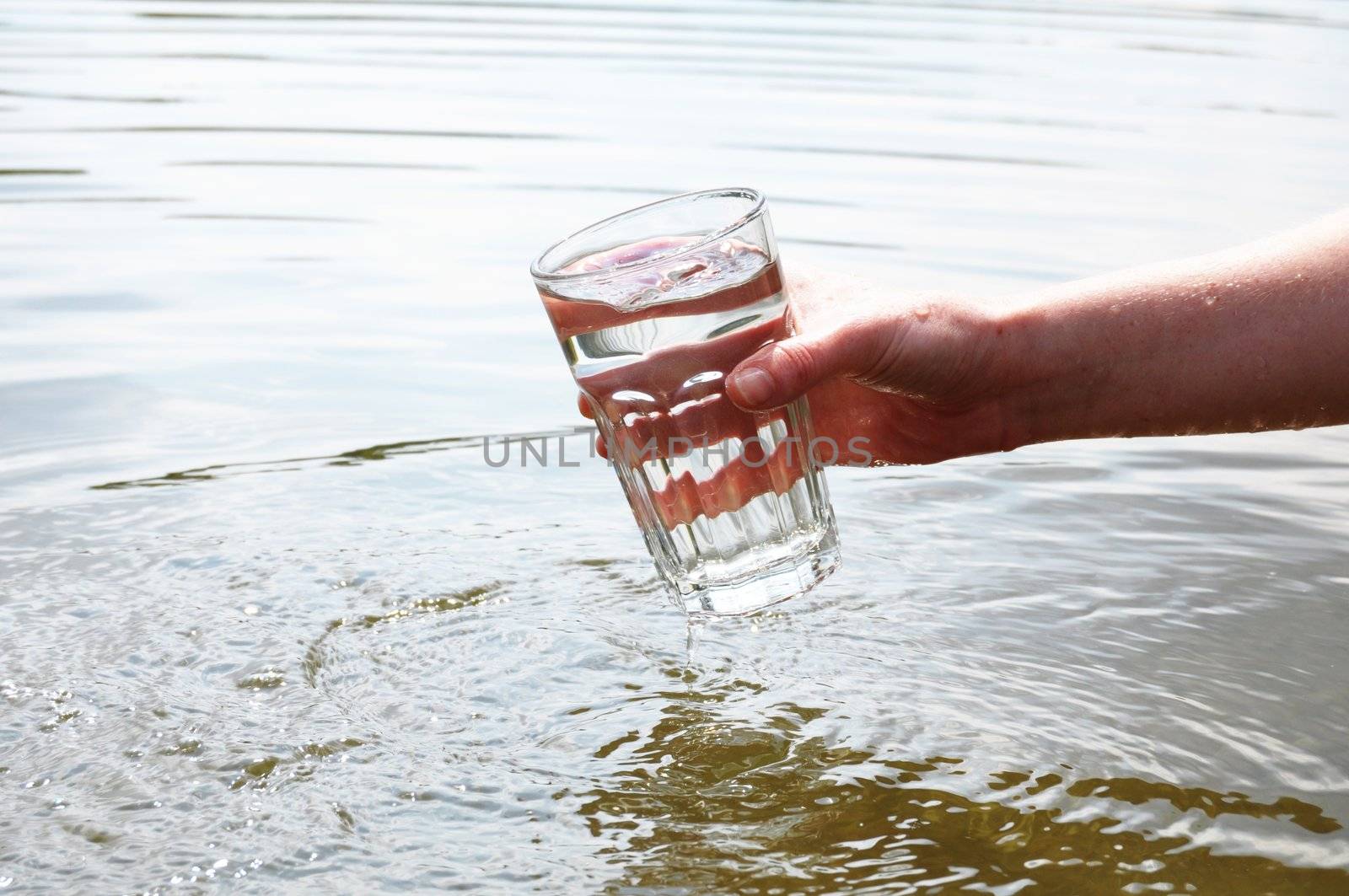drink water concept with hand and glass in summer